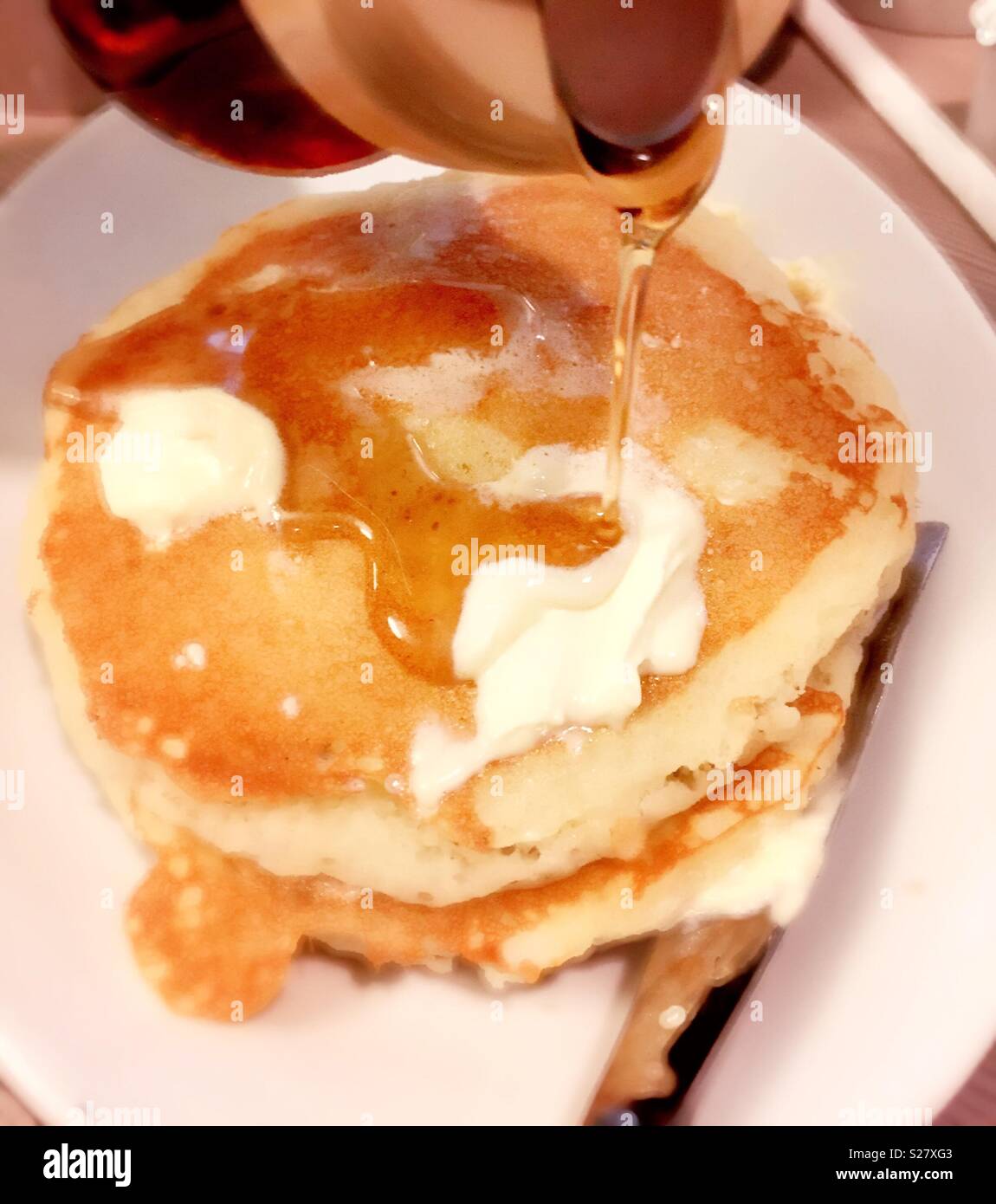 Stack of buttermilk pancakes with butter and maple syrup, USA Stock