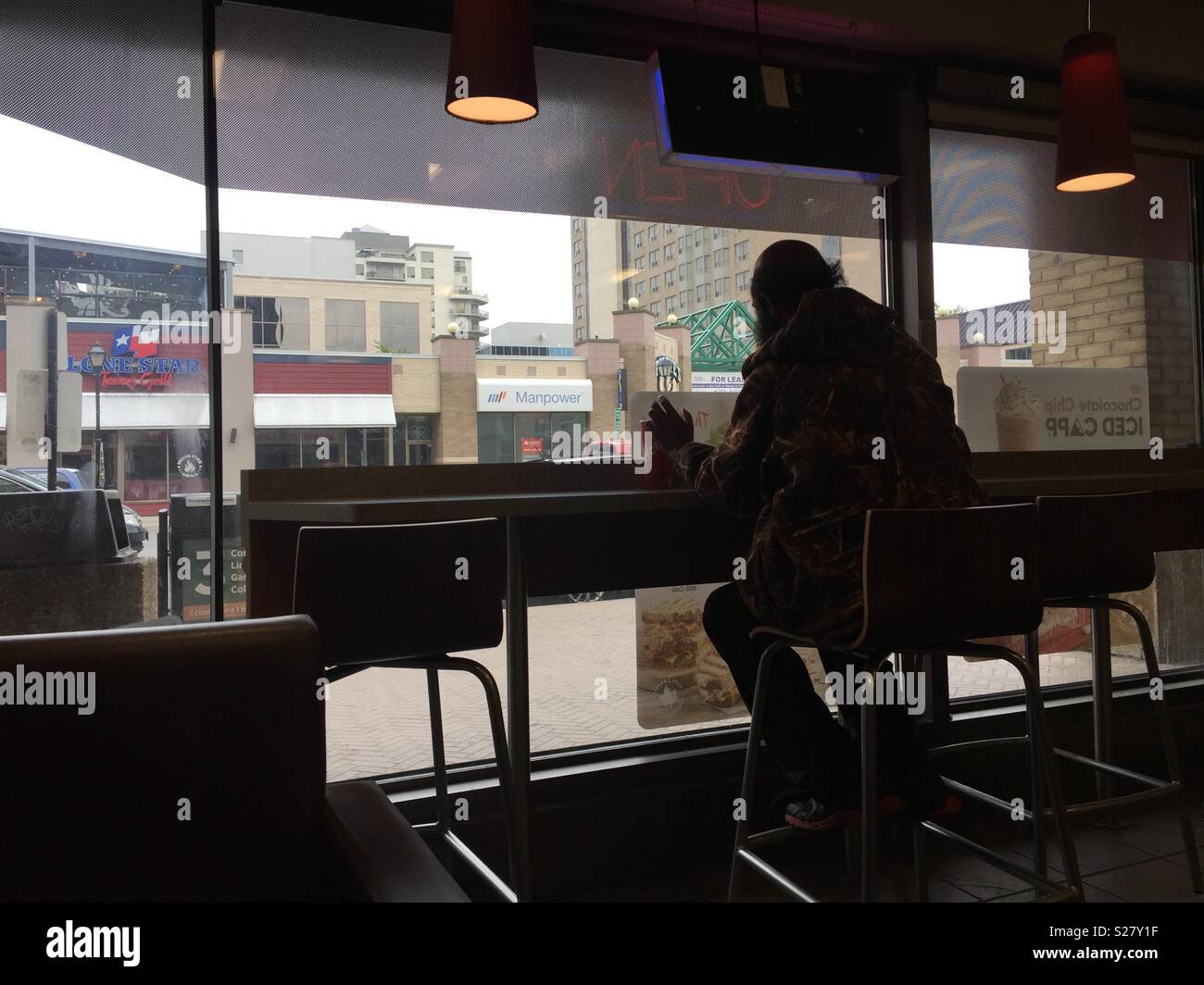 Man alone in a cafe - Smartphone Captured Stock Image