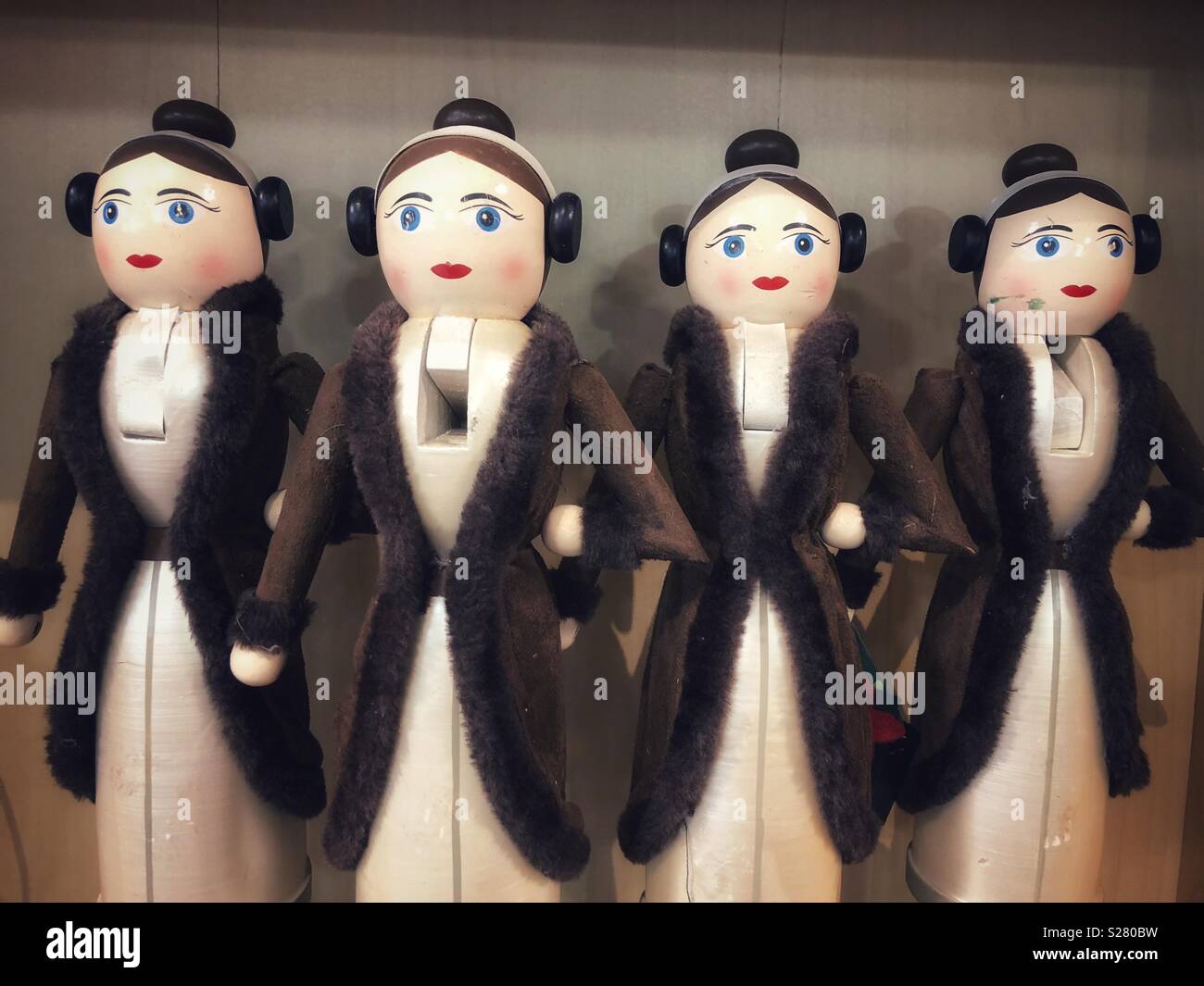 Four strange female nutcrackers wearing fur coats - Smartphone Captured Stock Image