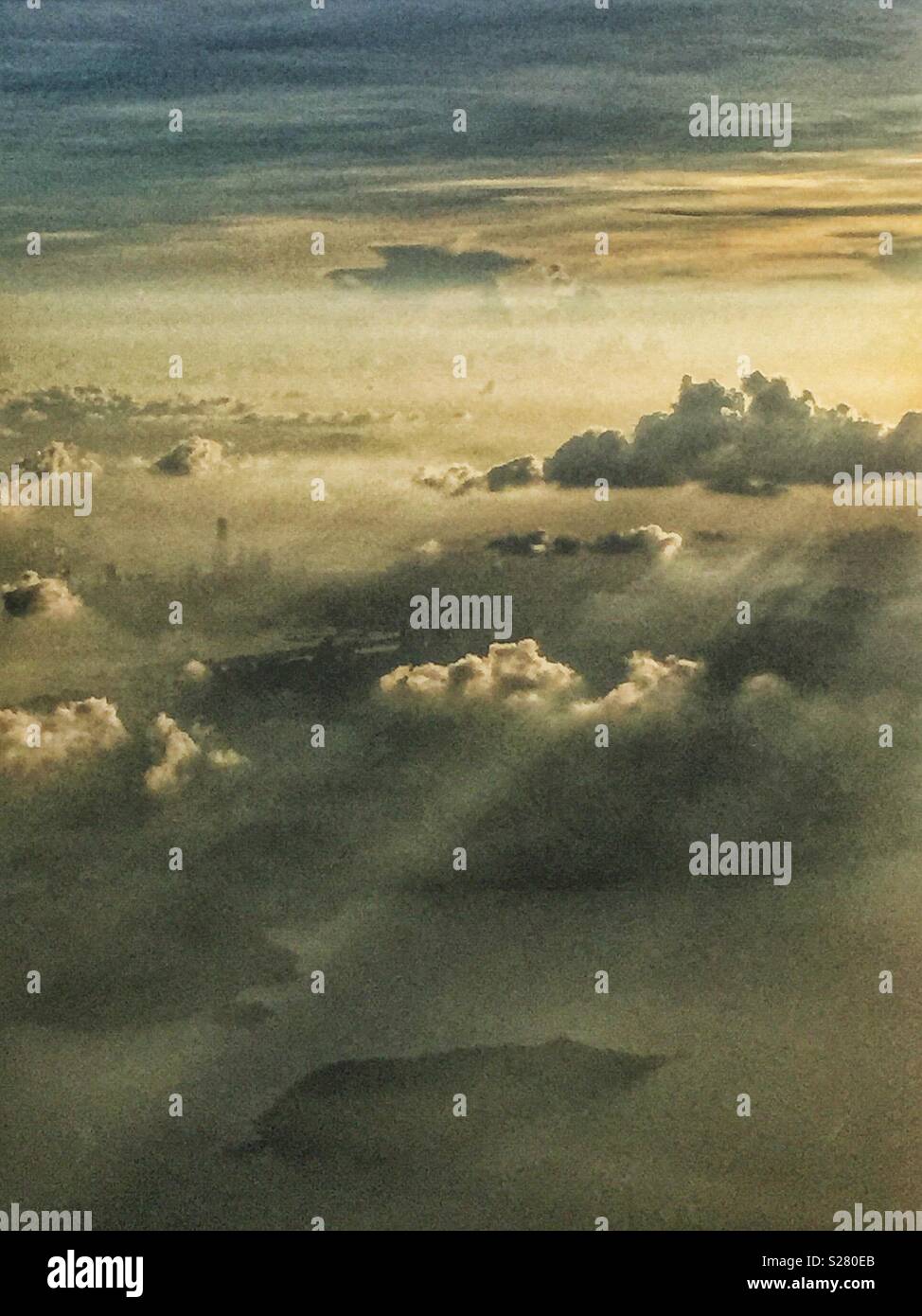 The ICC, Hong Kong's tallest building, just visible through the smog and haze in late afternoon light, from a passenger jet approaching the airport - Smartphone Captured Stock Image