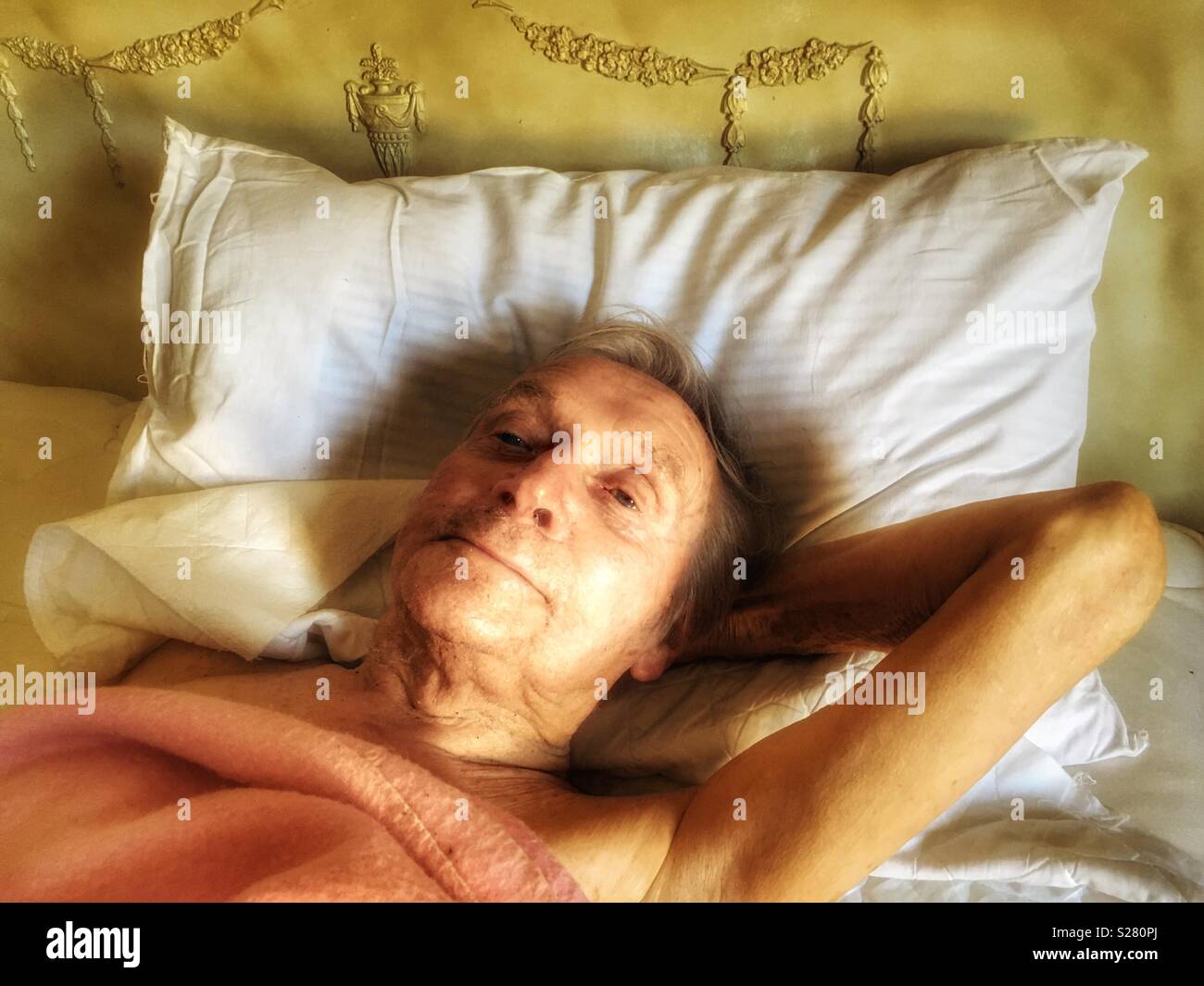 Elderly man in bed - Smartphone Captured Stock Image
