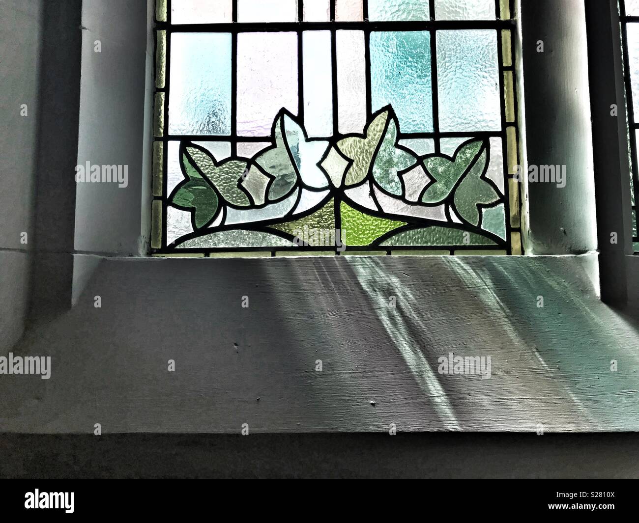 Stain glass window reflection and shadows Stock Photo