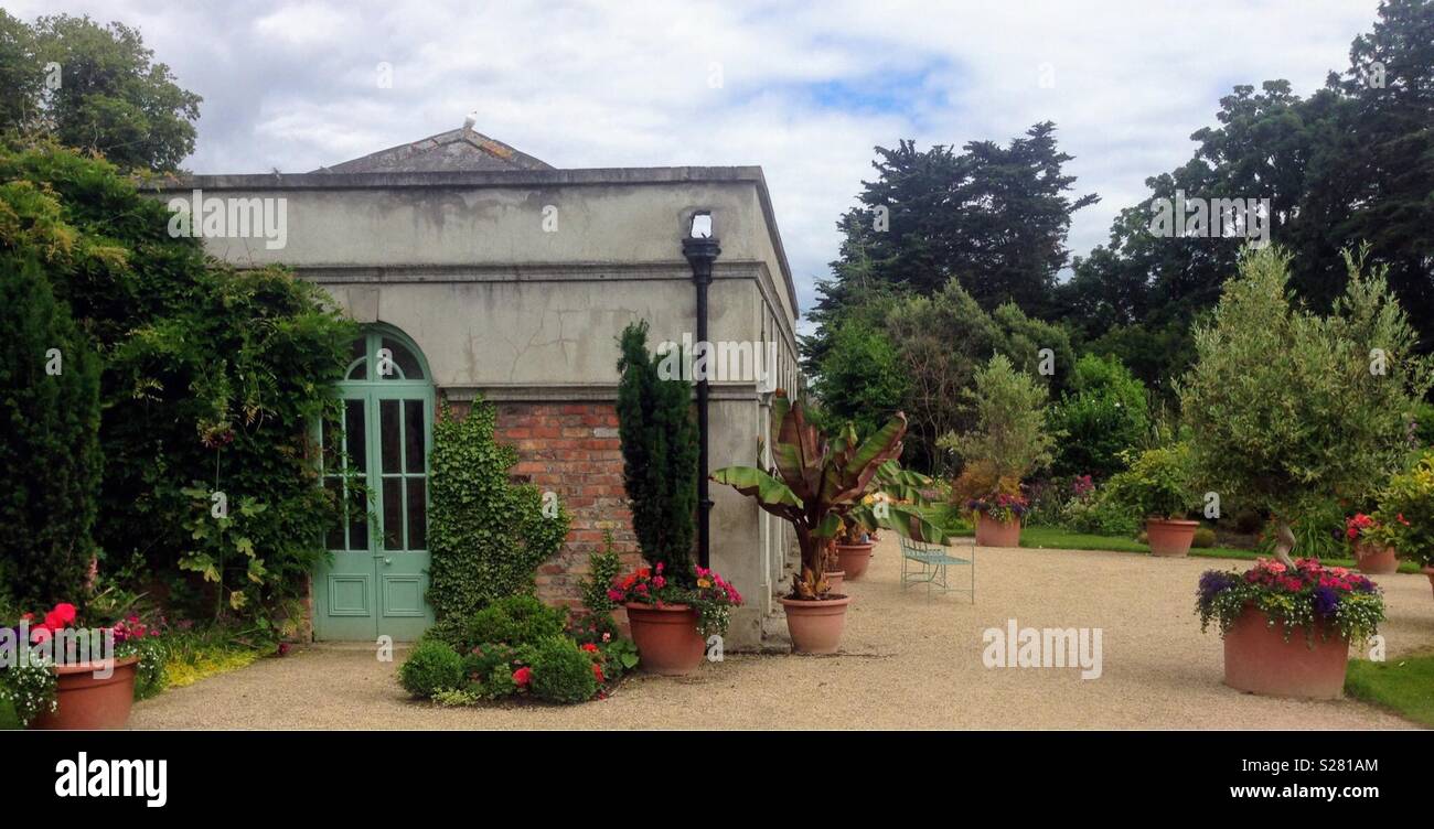 Selection of terracotta flower pots in a large garden. - Smartphone Captured Stock Image
