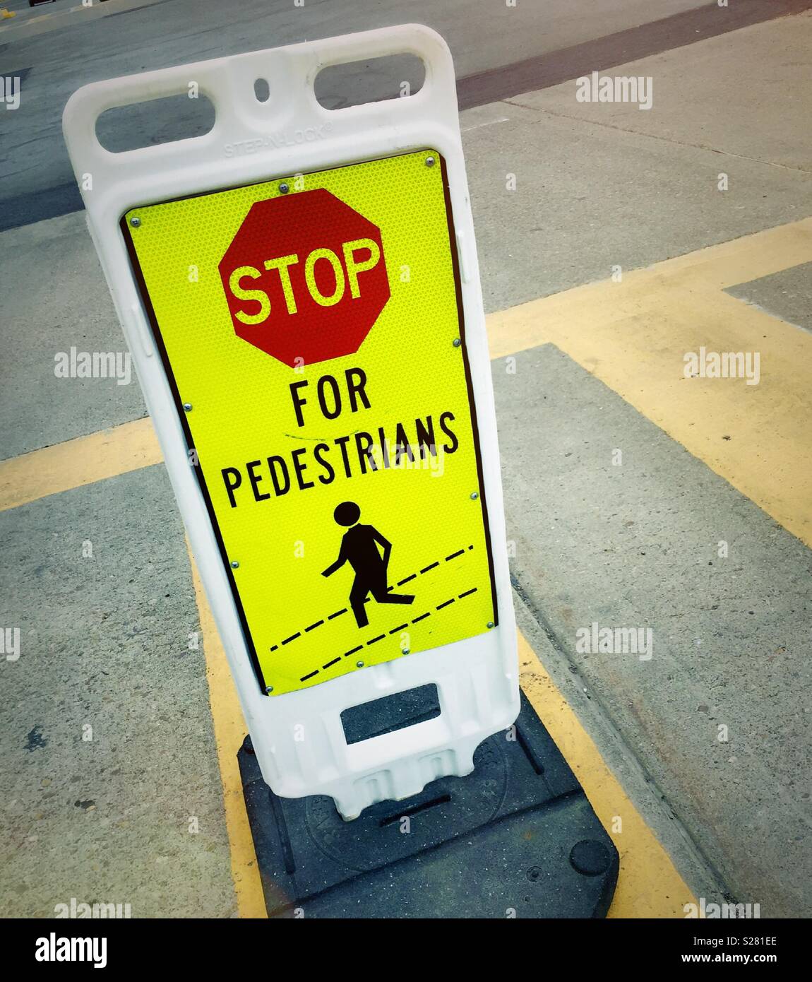 Stop for pedestrians traffic sign in crosswalk, USA - Smartphone Captured Stock Image