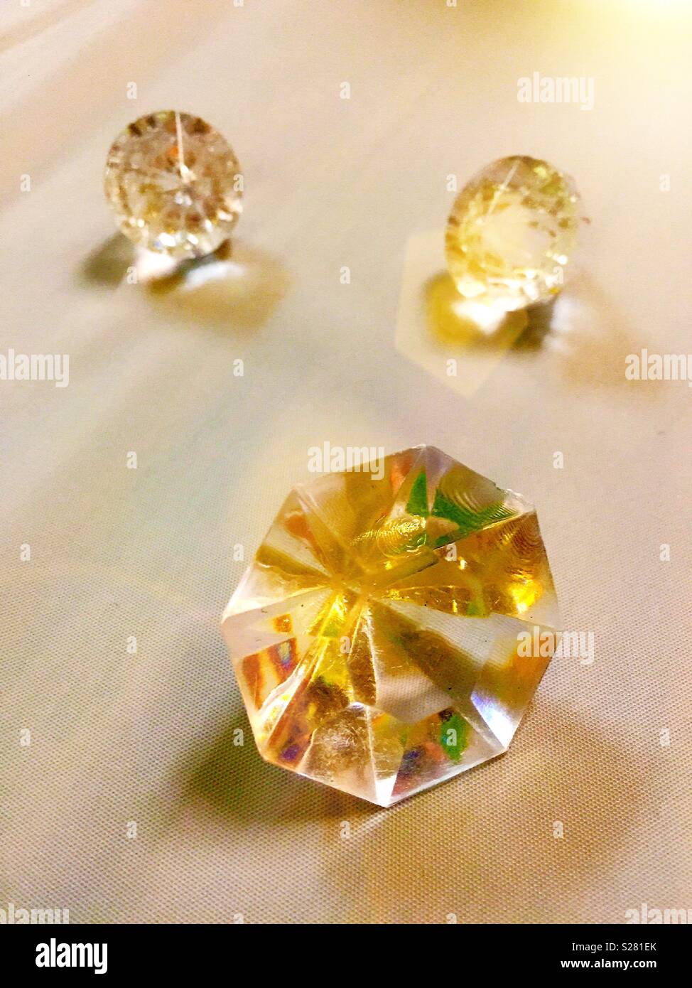 Plastic cut diamonds on display in retail store, USA - Smartphone Captured Stock Image