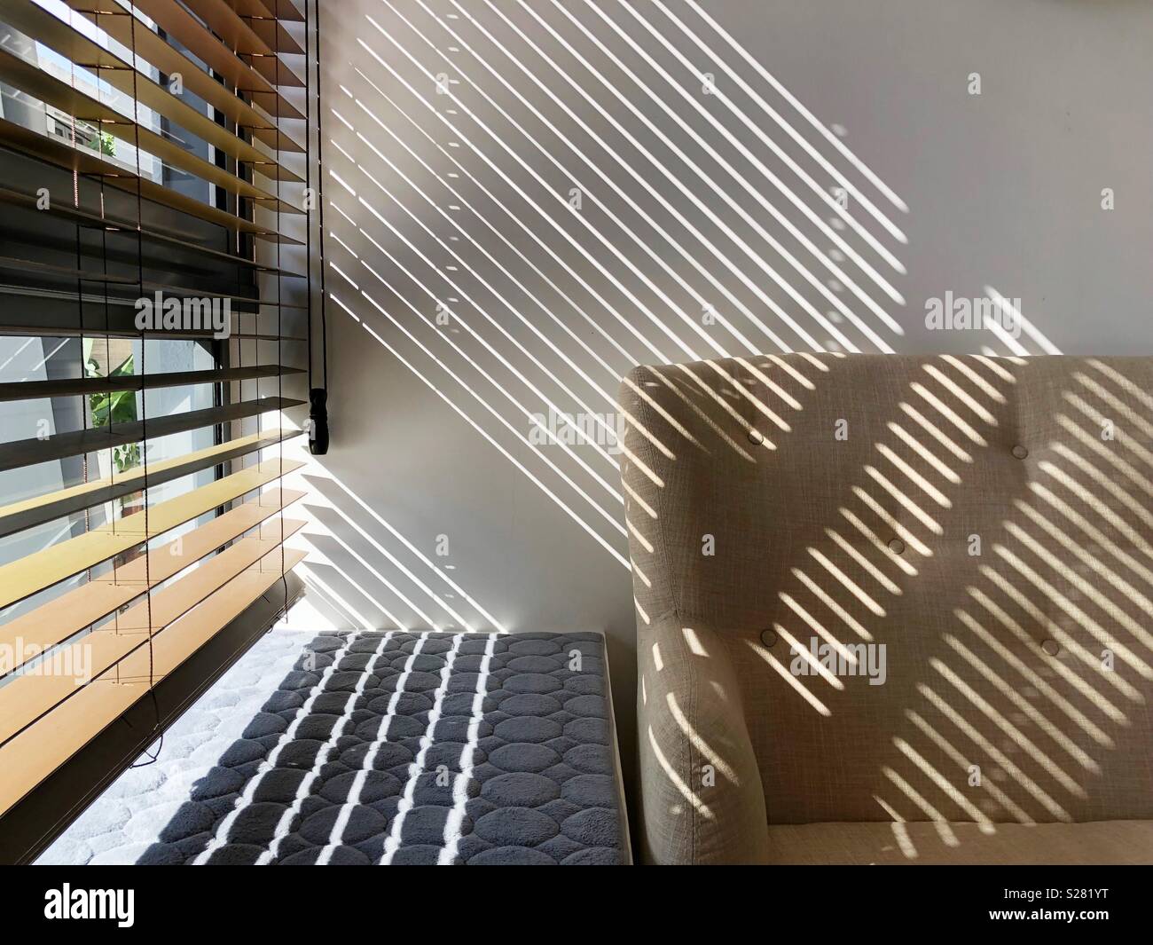 Sunlight shining through window blinds and creates beautiful reflection