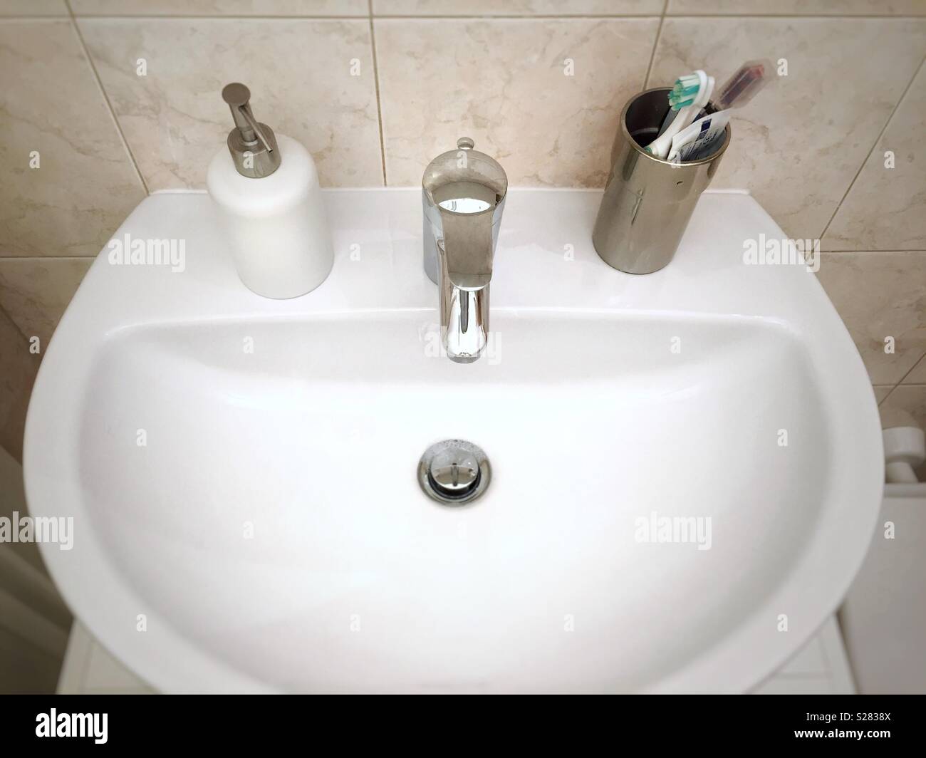 White sink with personal hygiene tools - Smartphone Captured Stock Image