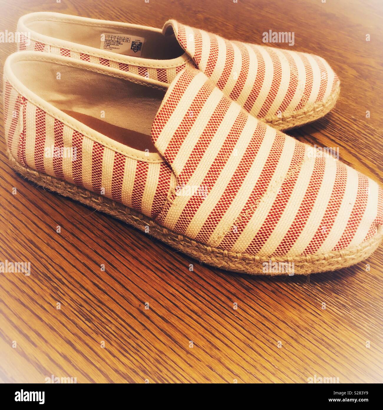 Stripy shoes on wood floor Stock Photo