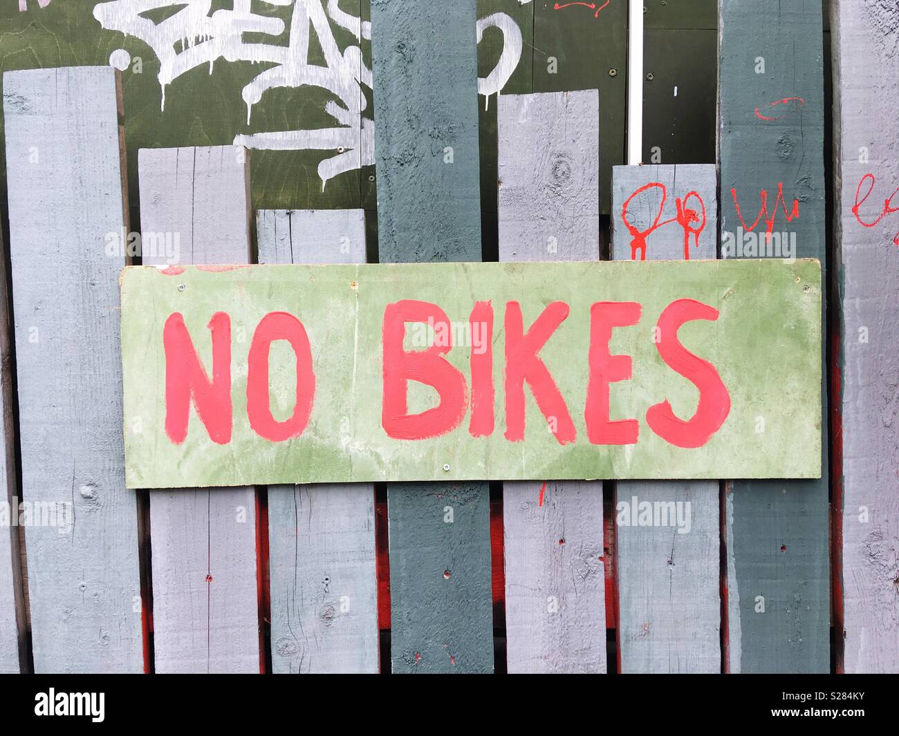 A Hand-painted sign proclaiming no bikes - Smartphone Captured Stock Image