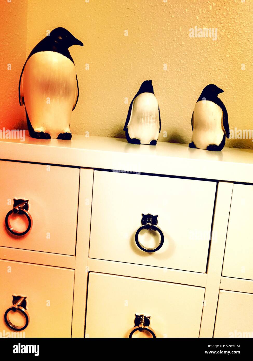 Cabinet with decorative penguin statues on top, USA - Smartphone Captured Stock Image