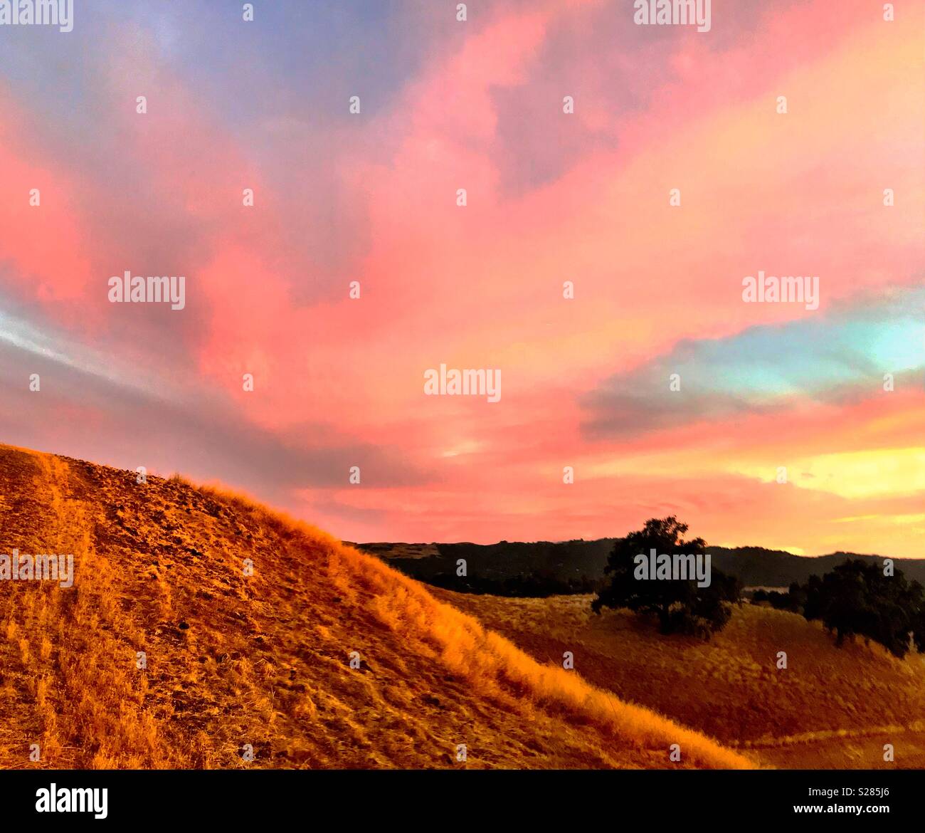 Sunset over dry grass hills - Smartphone Captured Stock Image