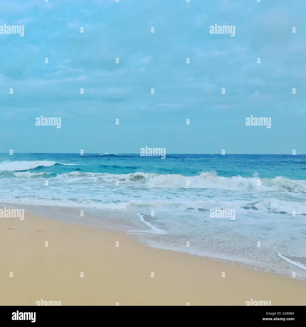 Seascape. Looking out to the ocean from a sandy beach. Square crop. - Smartphone Captured Stock Image