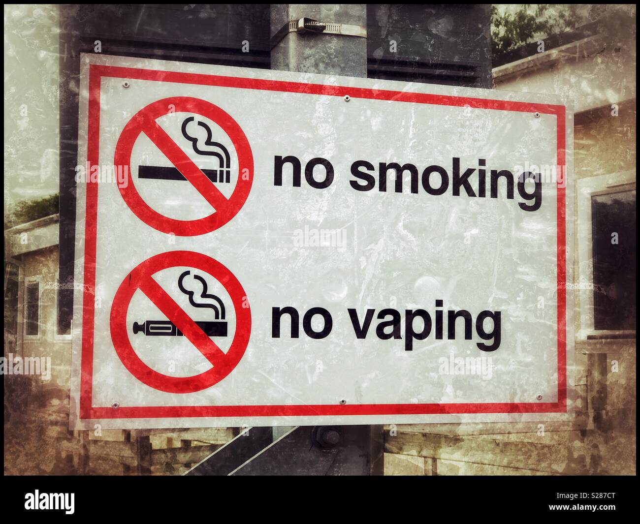 A grunge effect image of a warning sign advising that smoking and vaping is not permitted in this area. A warning about Cancer and an early death? Photo Credit - © COLIN HOSKINS. - Smartphone Captured Stock Image