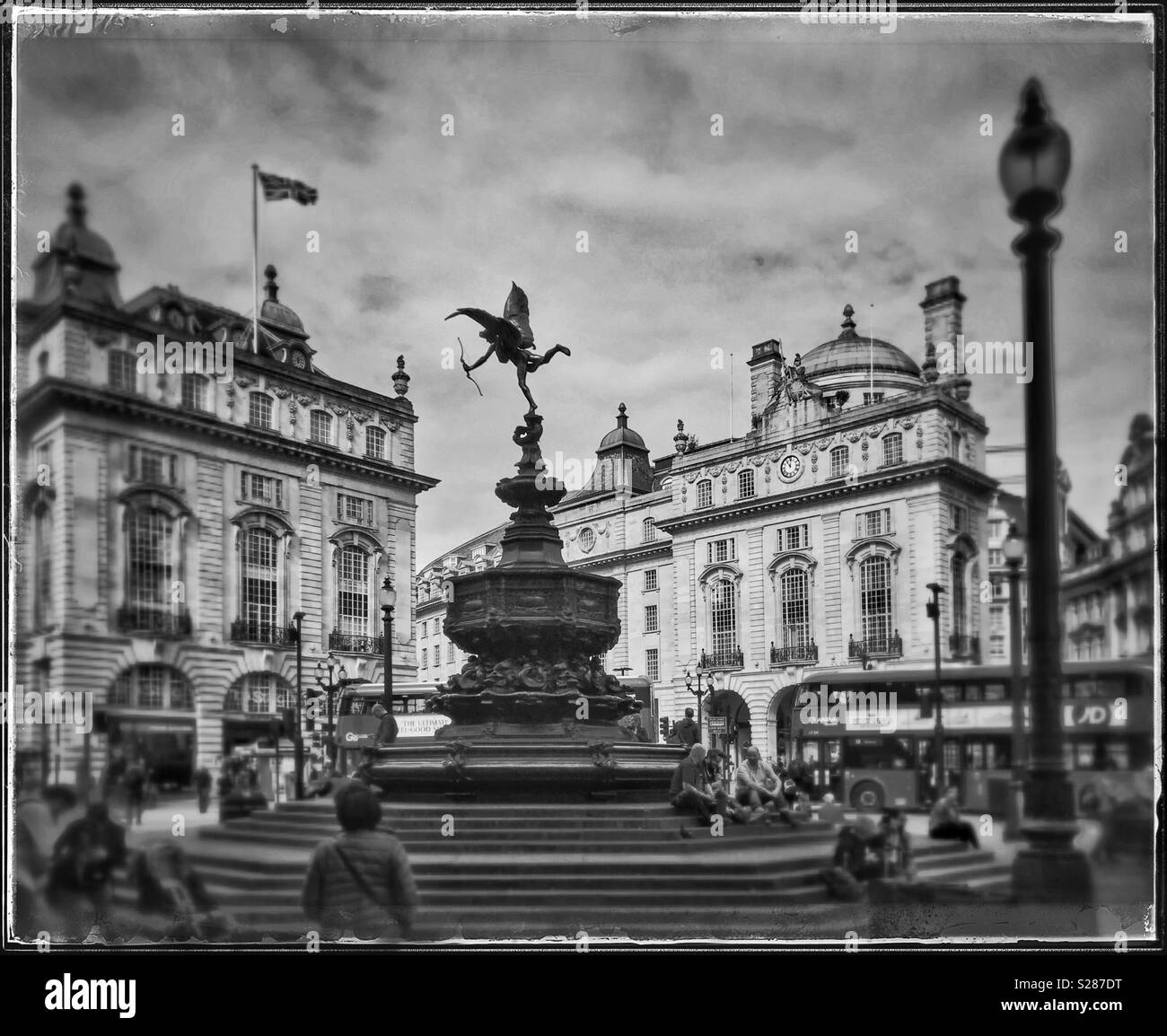 A monochrome, retro effect image of Piccadilly Circus in the centre of London, England. Clearly visible is the statue of Eros. Photo Credit - © COLIN HOSKINS. Stock Photo
