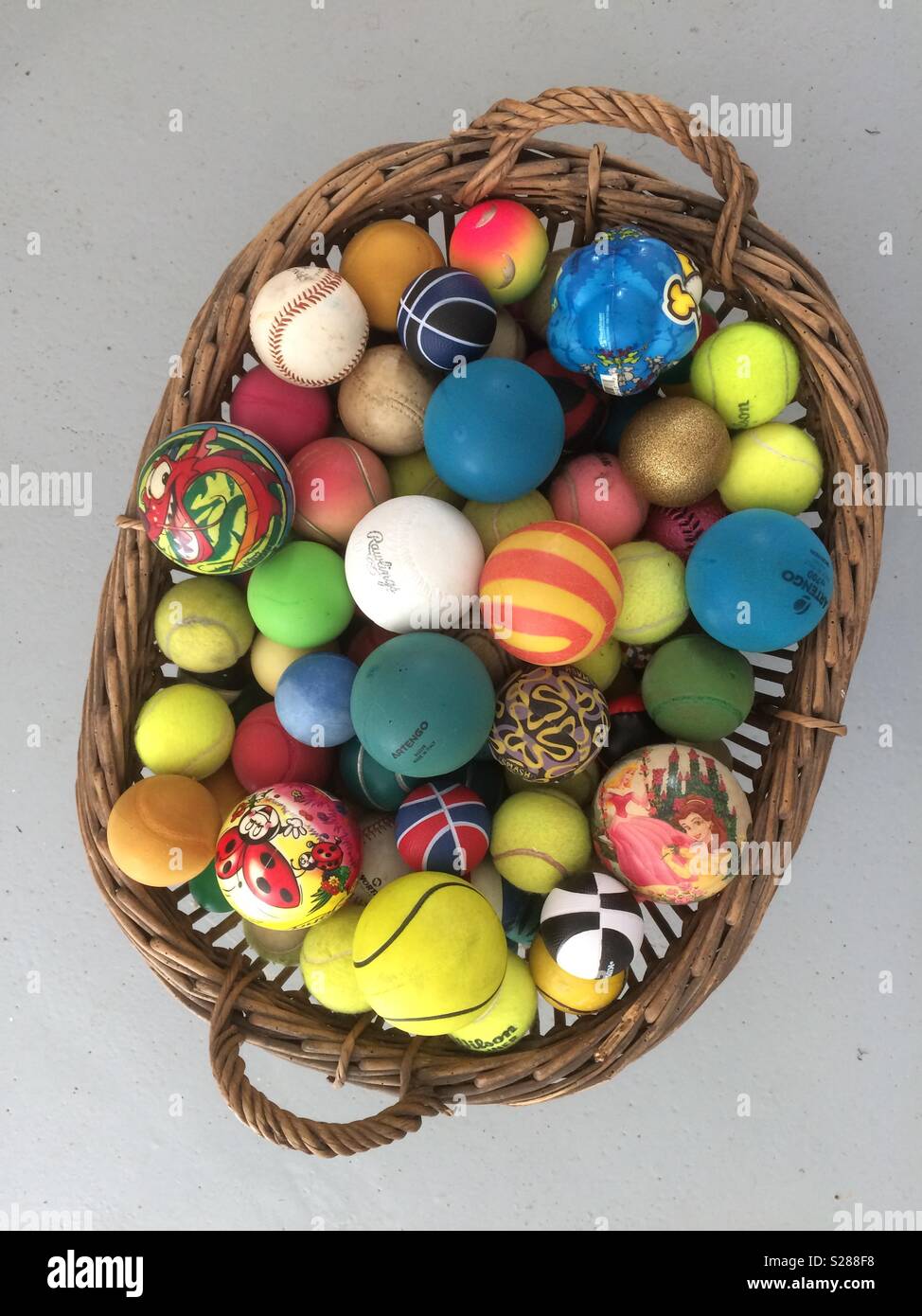 Multicolored yarn balls in a straw basket on a wooden table Stock Photo by  ©annakukhmar 40790863