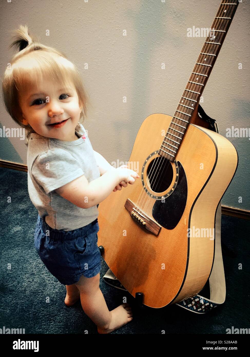 Cute baby girl and an acoustic guitar, USA Stock Photo - Alamy