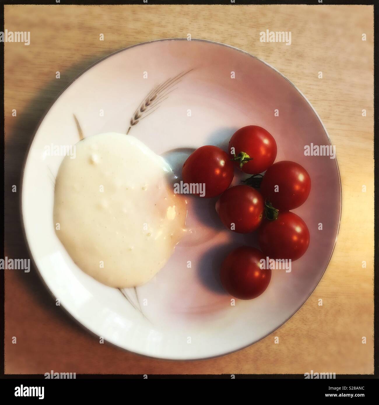 Garden fresh cherry tomatoes on grandmothers decorative plate - Smartphone Captured Stock Image