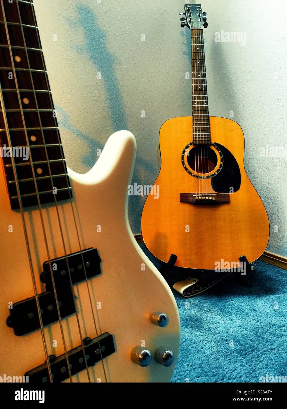 Guitars on stands in a home music room, USA - Smartphone Captured Stock Image