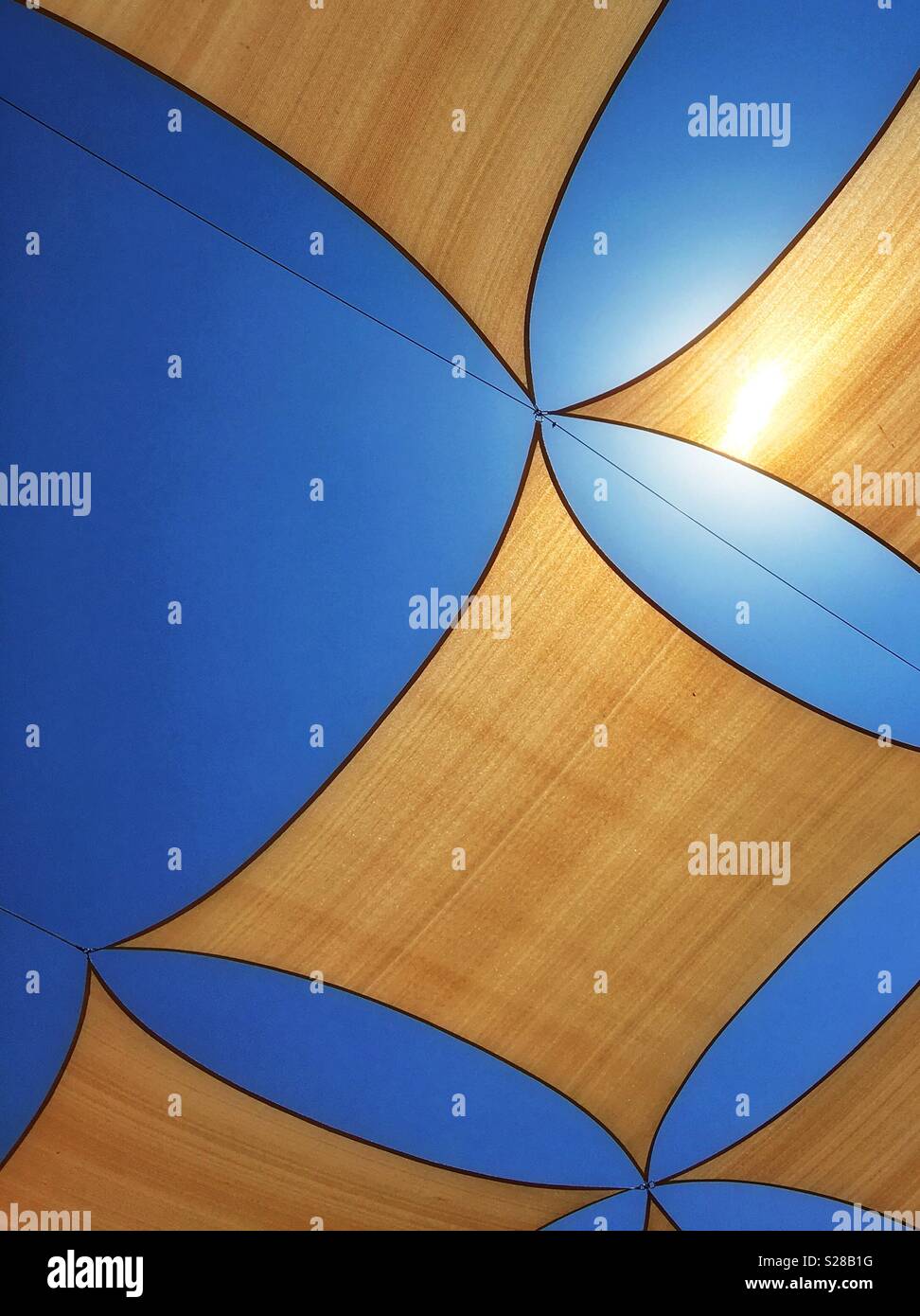 Sun canopies against a vivid blue sky - Smartphone Captured Stock Image