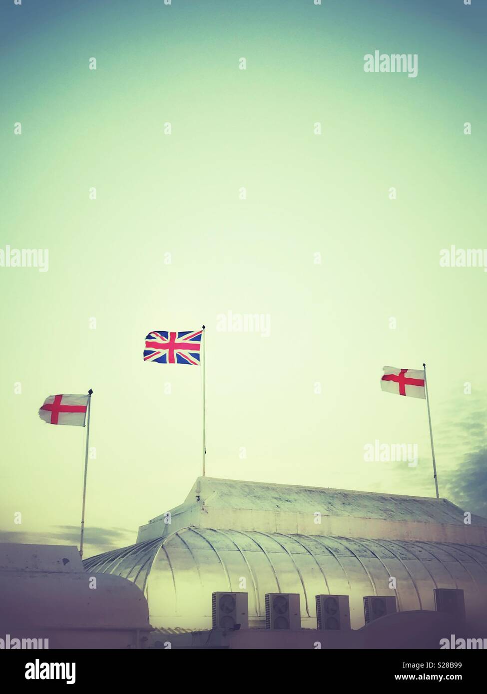 The British and English Flags fluttering on top of the pier at Burnham-on-Sea, Somerset - Smartphone Captured Stock Image