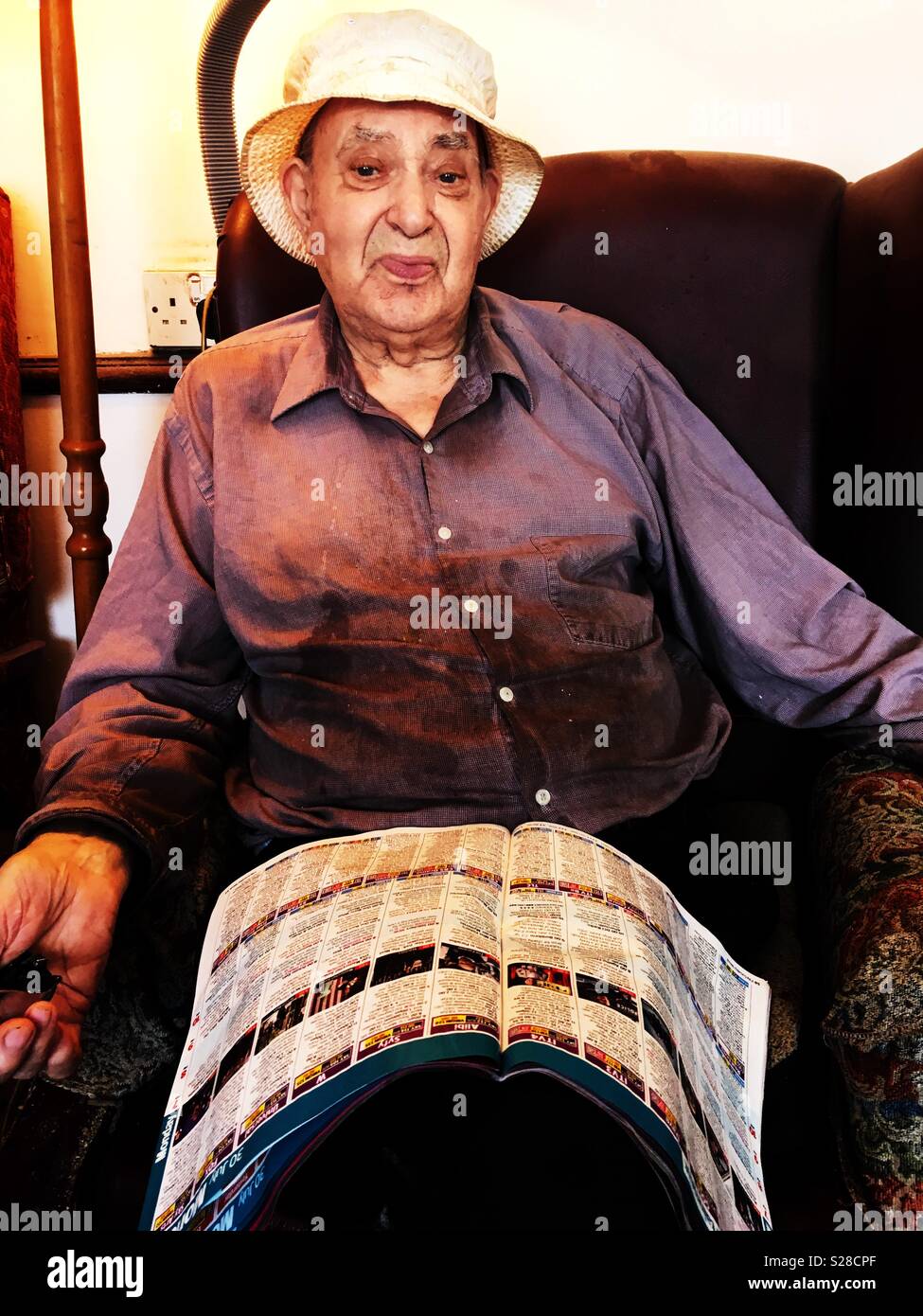 Elderly man sitting indoors during the long hot summer of 2018, Suffolk, England. - Smartphone Captured Stock Image