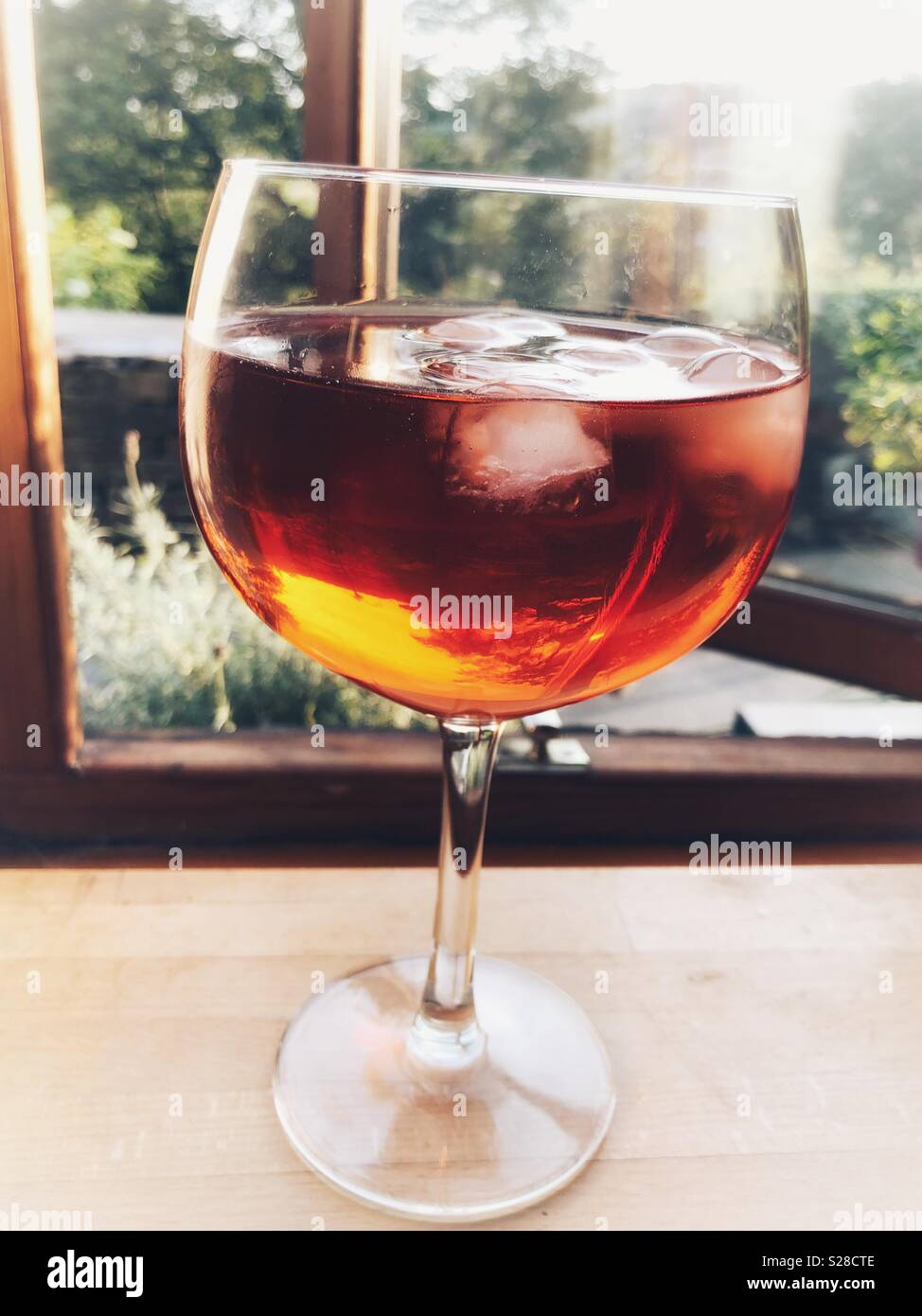 Glass of gin with rose mixer and ice cubes Stock Photo Alamy