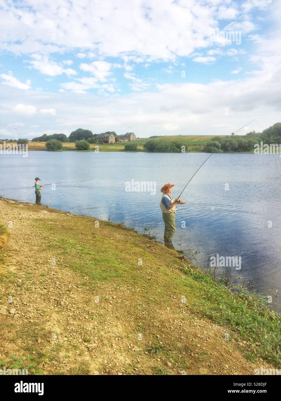 https://c8.alamy.com/comp/S28DJF/boy-and-his-grandfather-fishing-for-trout-at-scout-dike-reservoir-pennistone-south-yorkshire-england-S28DJF.jpg