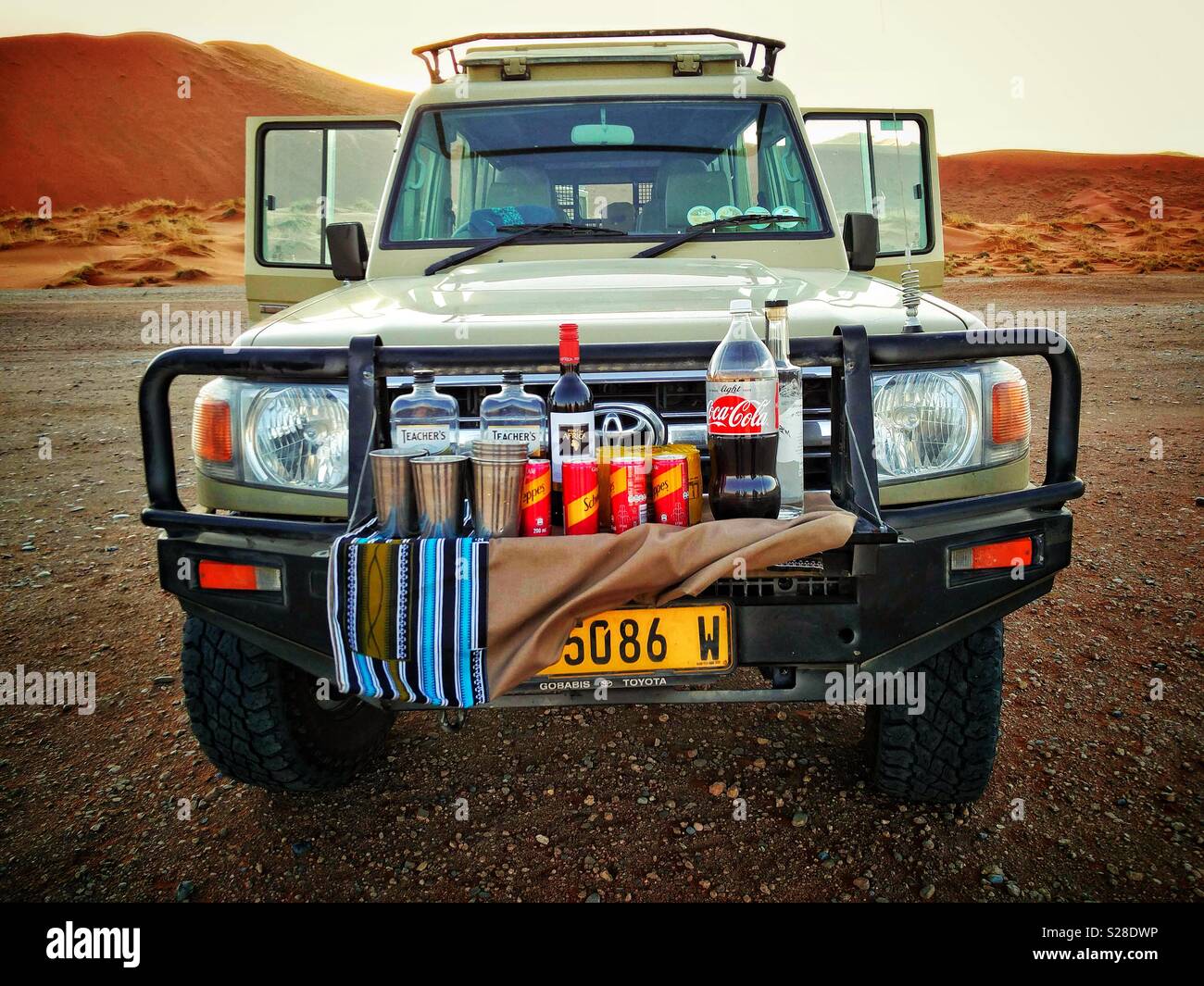 A makeshift bar on the front of a custom Toyota Land Cruiser, ready for a sundown drink. Sossusvlei, Namibia. - Smartphone Captured Stock Image