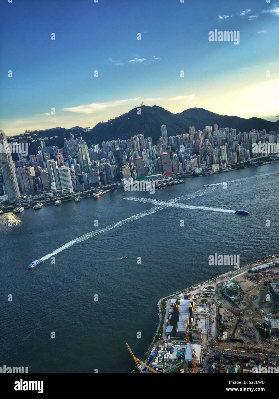 Passenger ferries on Victoria Harbour and the highrise of Hong Kong Island - Smartphone Captured Stock Image