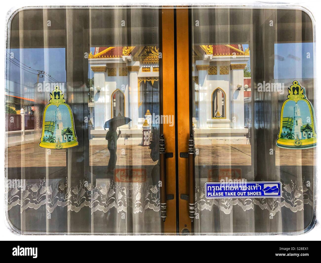 Window reflection of a Buddhist temple in Bangkok, Thailand. - Smartphone Captured Stock Image