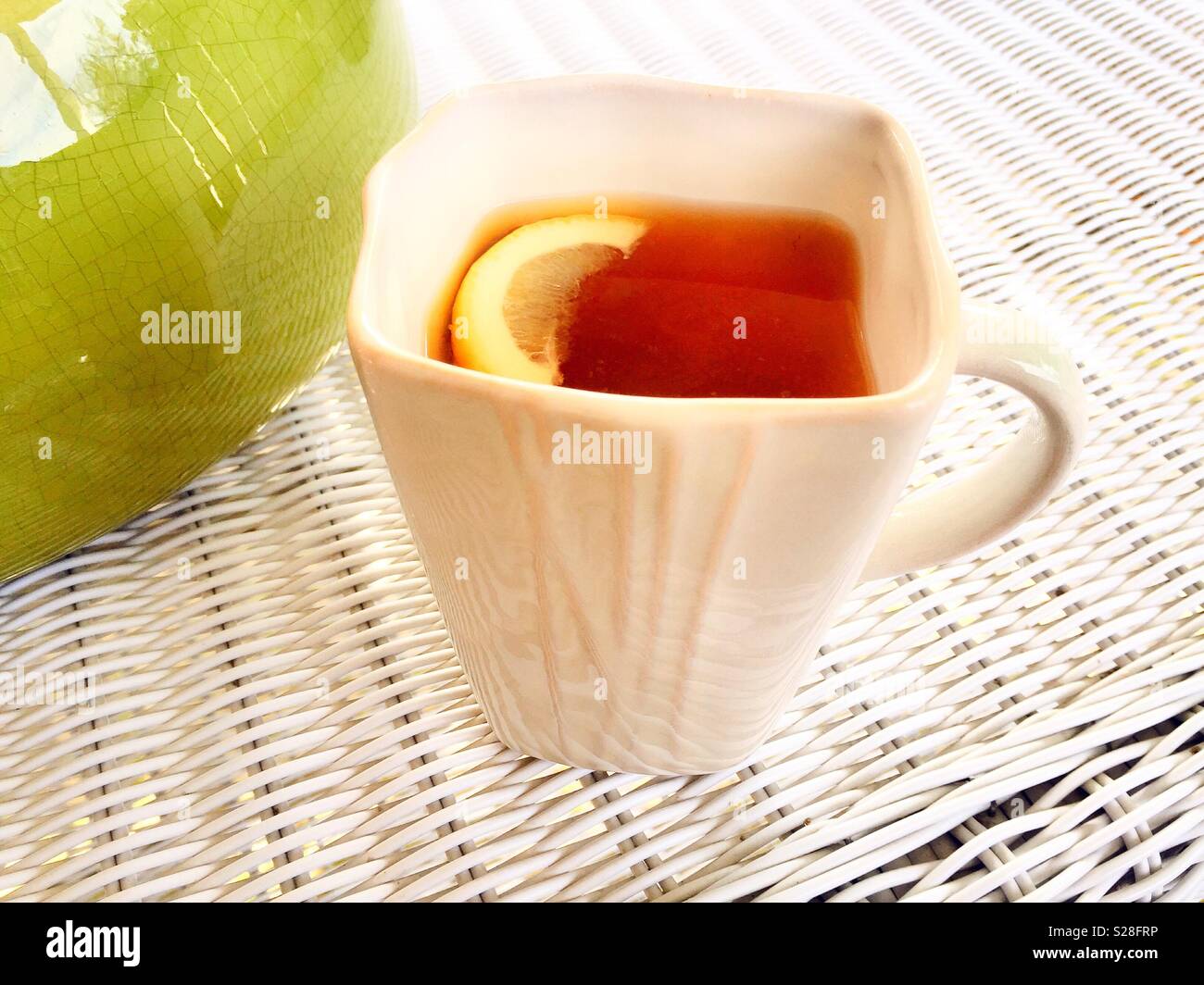 Hot tea and lemon slice in a white china cup - Smartphone Captured Stock Image