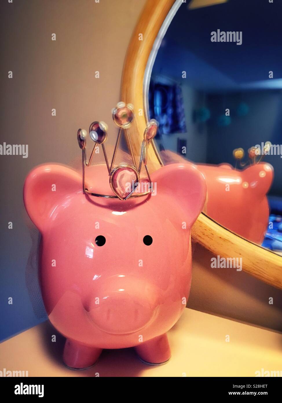 Close up of a whimsical pink piggy bank wearing a crown, USA - Smartphone Captured Stock Image
