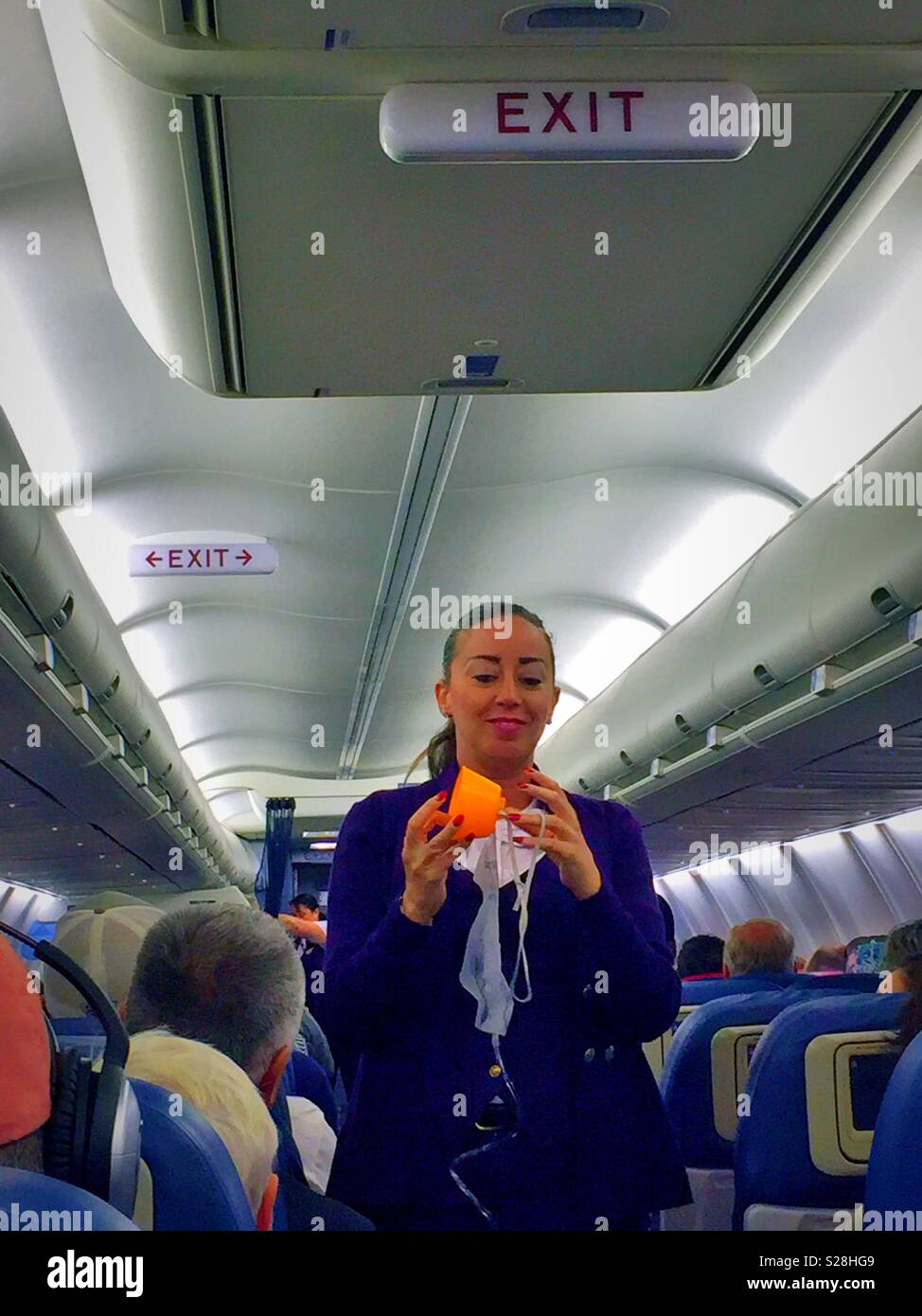 Flight attendant demonstrating the use of an oxygen mask during the in-flight Security demonstration, delta airlines, USA Stock Photo