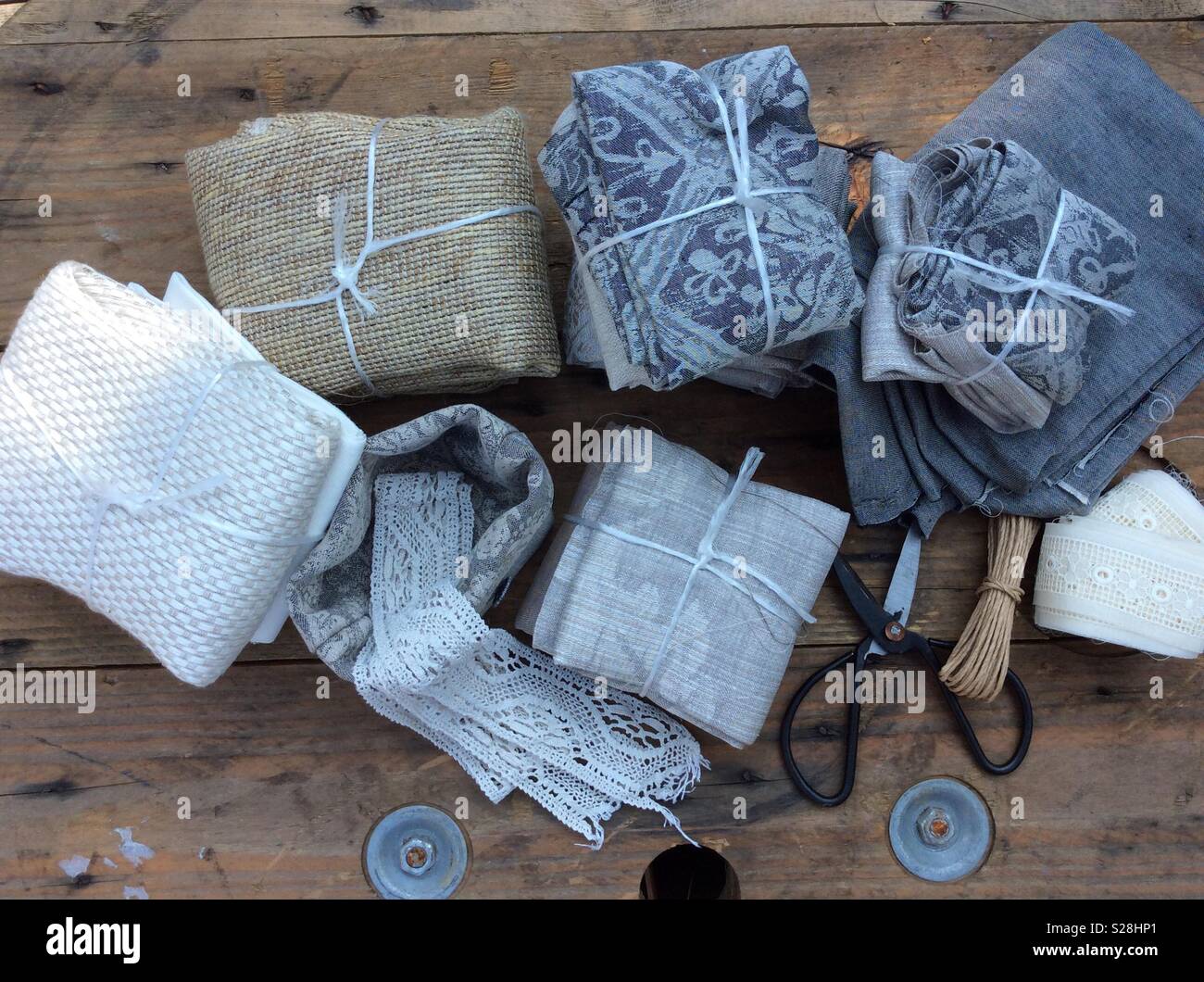 View from above on present packages of vintage linen displayed on wooden table Stock Photo