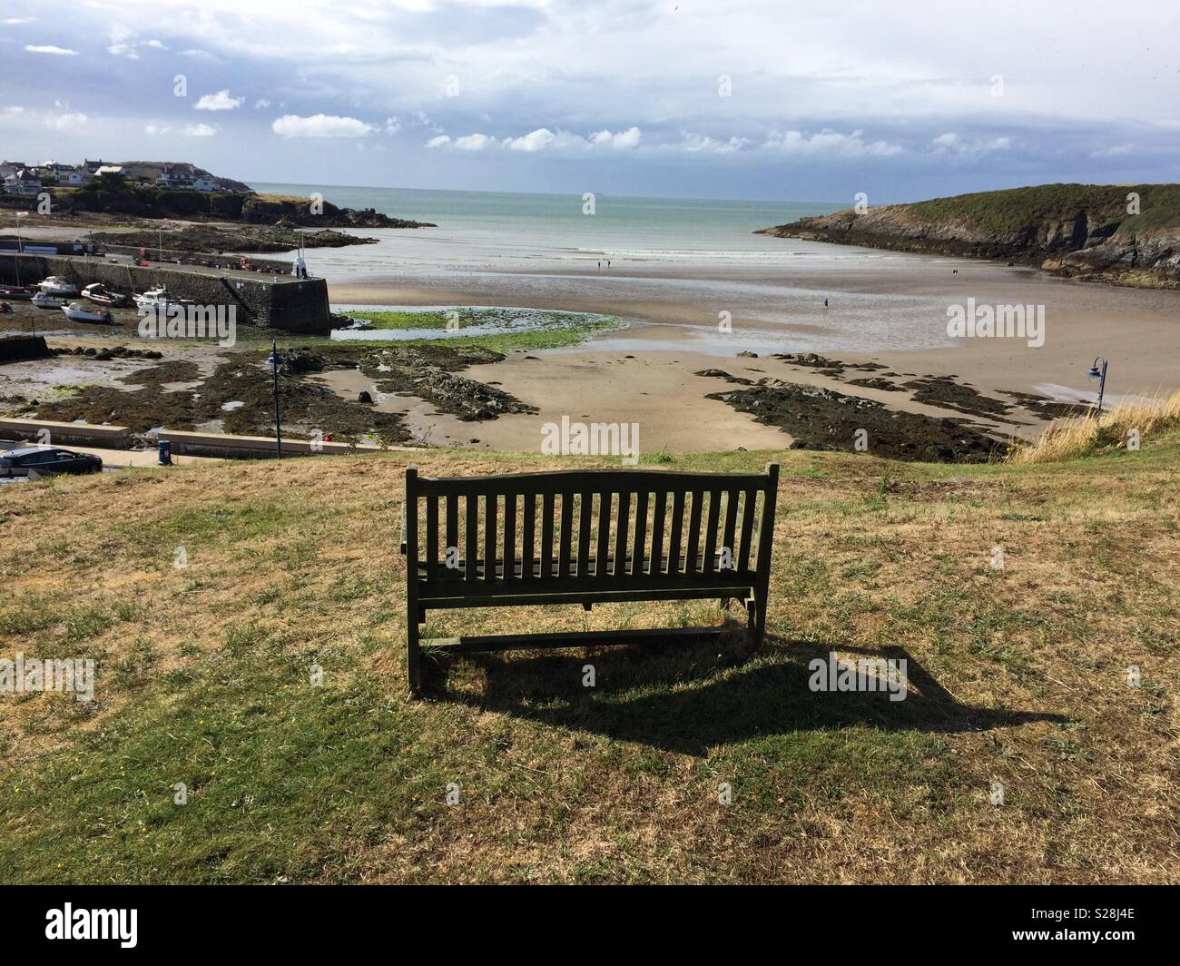 An empty bench above Cemaes Bay, Anglesey, North Wales, UK - Smartphone Captured Stock Image