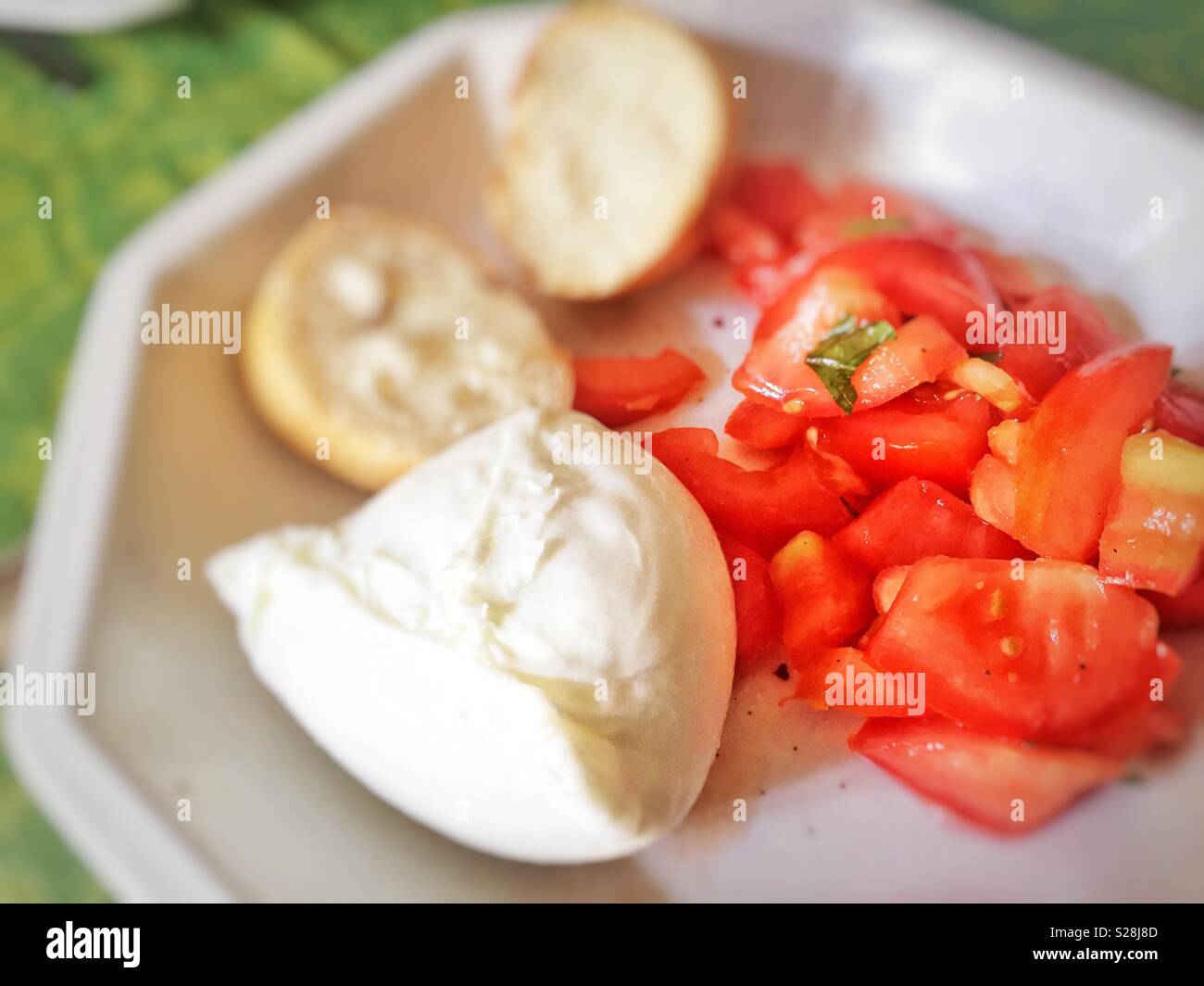 Fresh Italian caprese salad with mozzarella cheese, chopped tomatoes and sliced bread - Smartphone Captured Stock Image