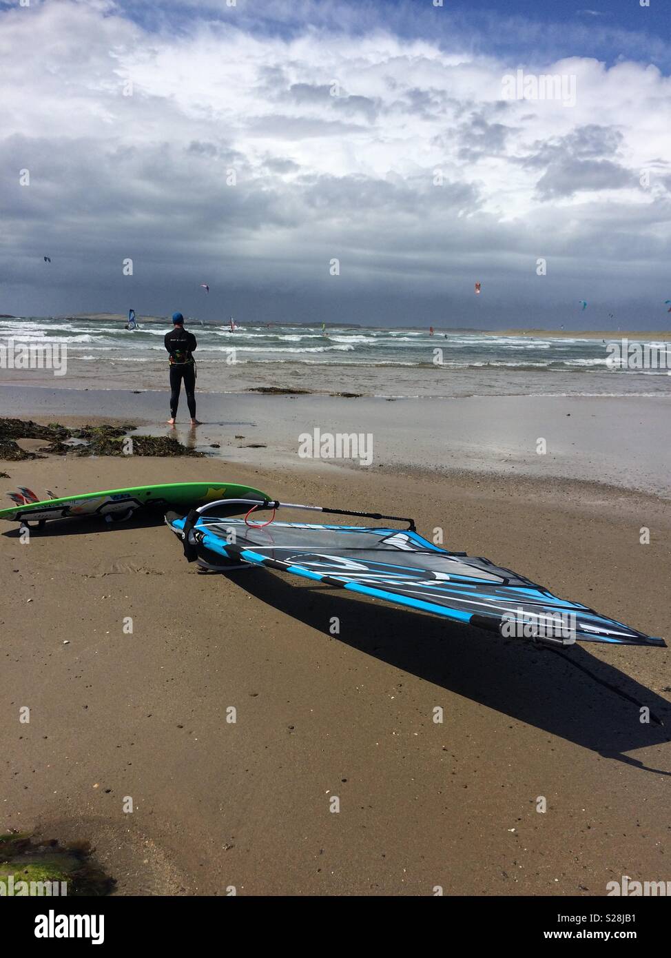 Surfer in Rhosneigr, Anglesey, North Wales, UK - Smartphone Captured Stock Image