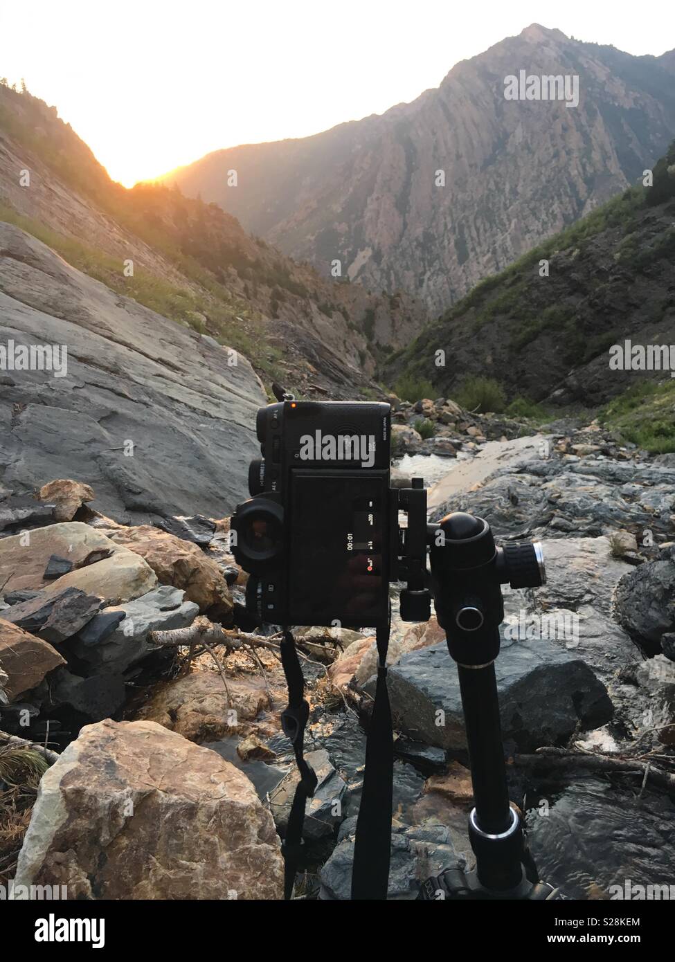 A fujifilm camera sits atop a tripod taking a time lapse of a mountain  sunset in Utah Stock Photo - Alamy