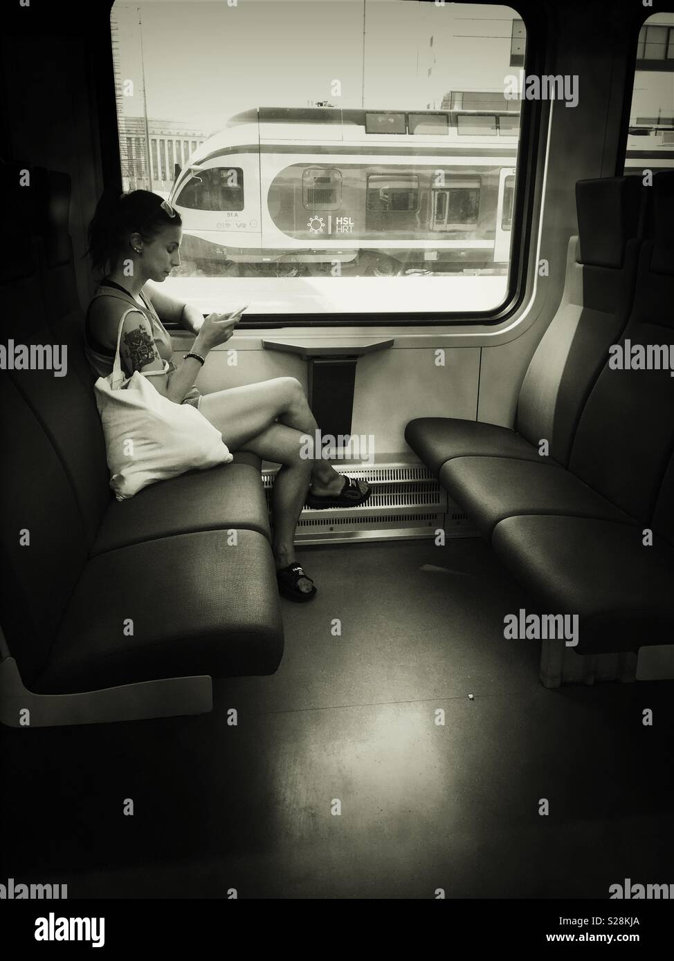 Young Lady in Commuter Train - Smartphone Captured Stock Image