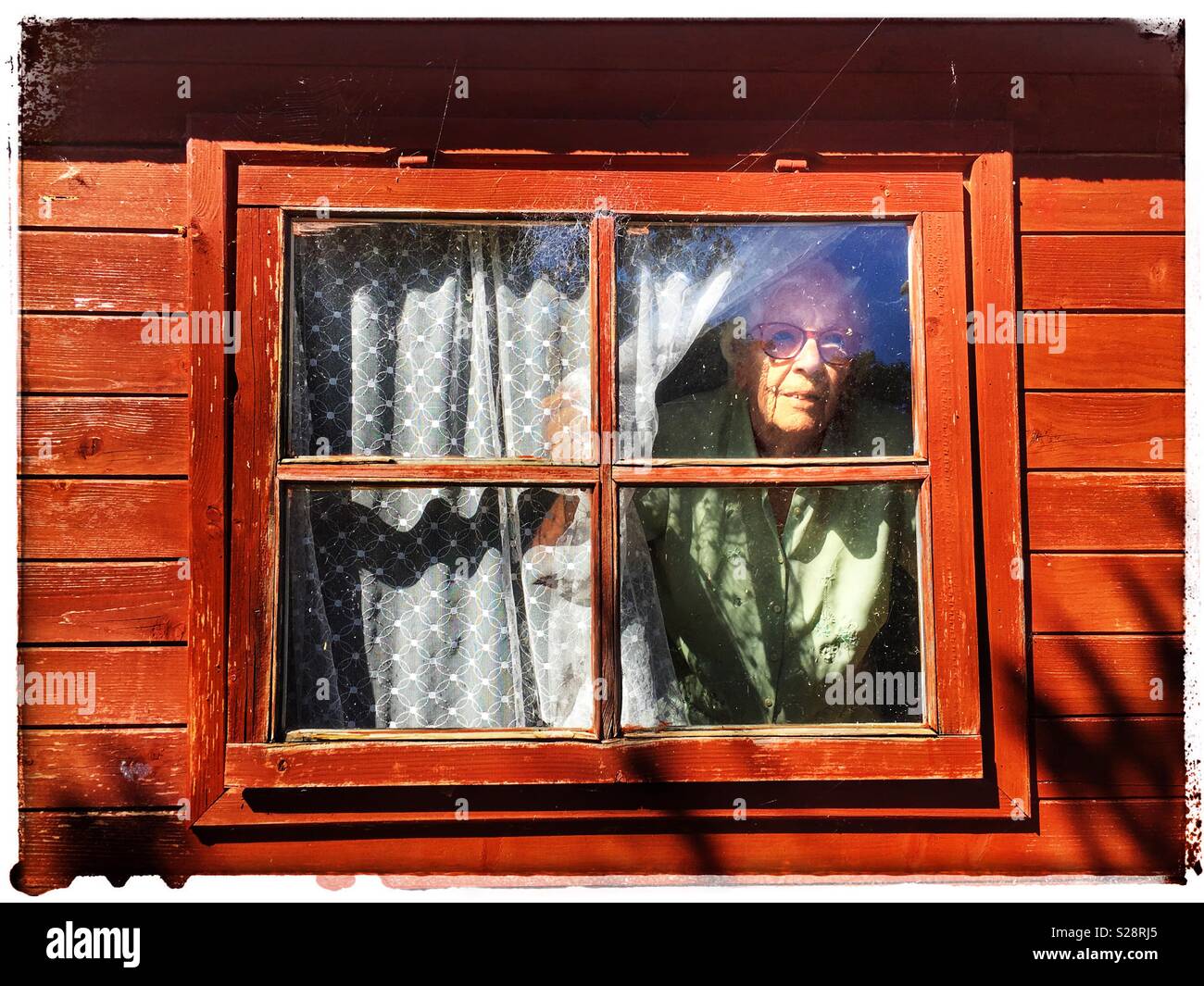 Elderly British woman with age-related macular degeneration in her eyes living alone - Smartphone Captured Stock Image