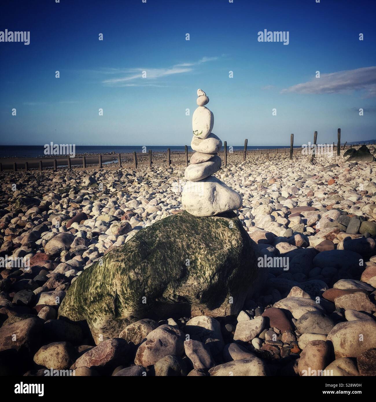 Stacked pebbles on beach in Wales UK - Smartphone Captured Stock Image