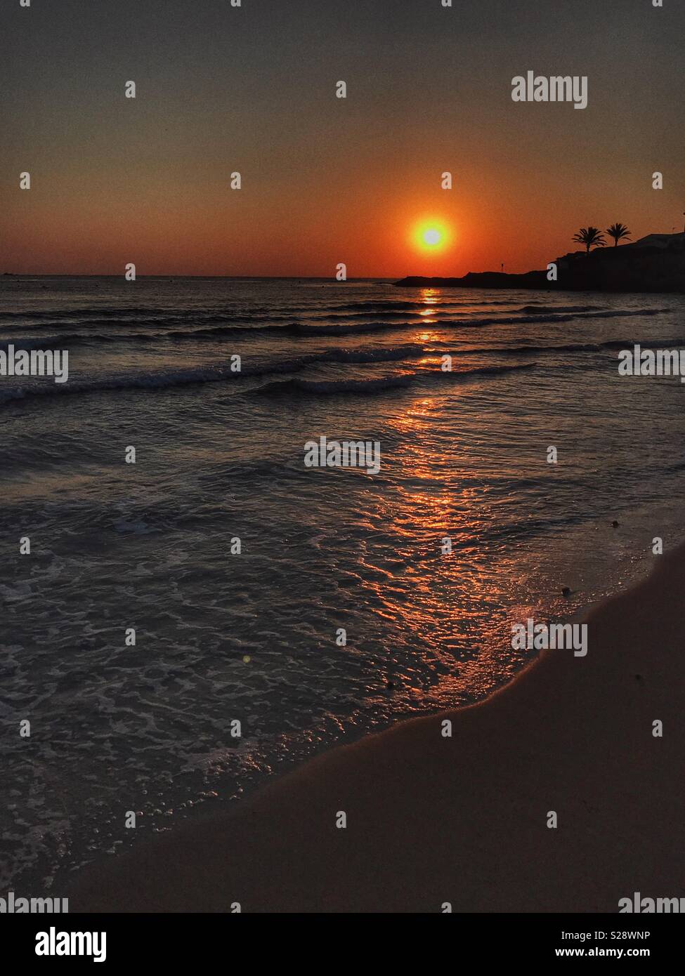 Sunrise over sea from beach Stock Photo