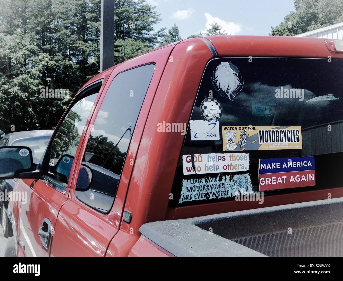 Pale photo of red pickup with bumper stickers in North Carolina parking lot - Smartphone Captured Stock Image