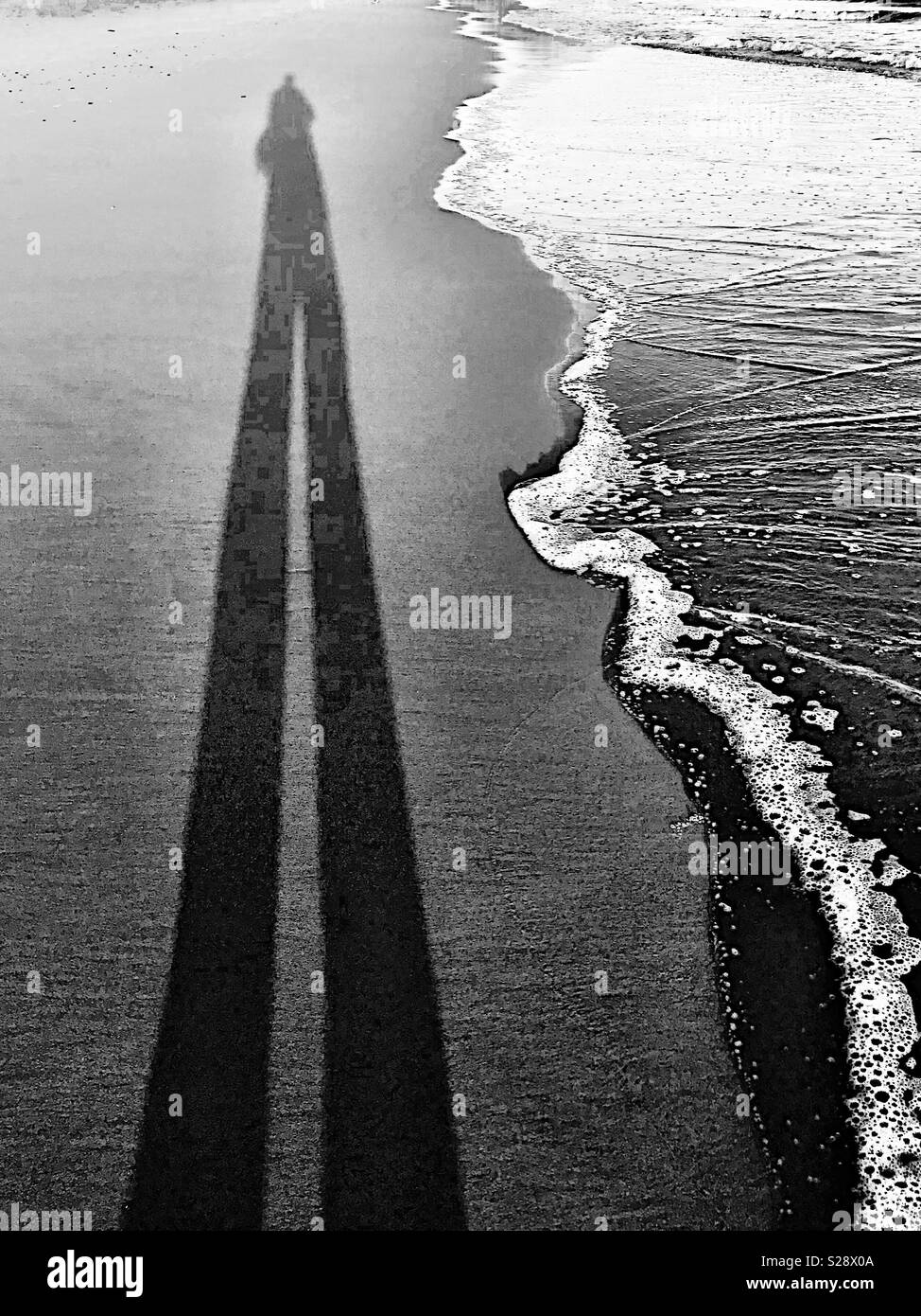 Tall shadow at edge of surf line - Smartphone Captured Stock Image