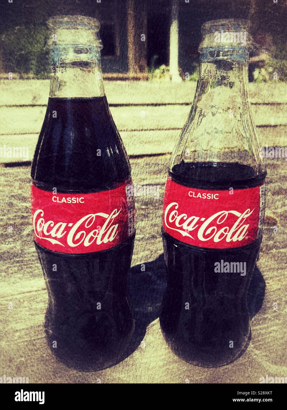Two Coca Cola bottles Stock Photo - Alamy