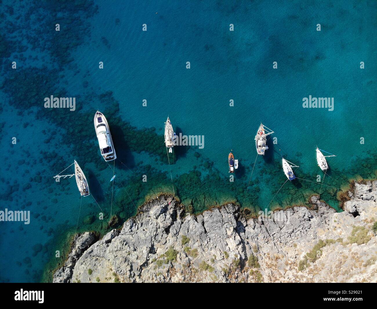 Sailing boats from above in lovely clear Mediterranean water - Smartphone Captured Stock Image