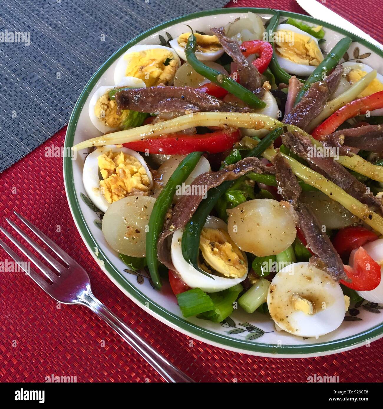 Salade Niçoise - green salad, cherry tomatoes, new potatoes, green beans, anchois, eggs, olives and balsamic vinegar. A tasty and healthy salad - Smartphone Captured Stock Image