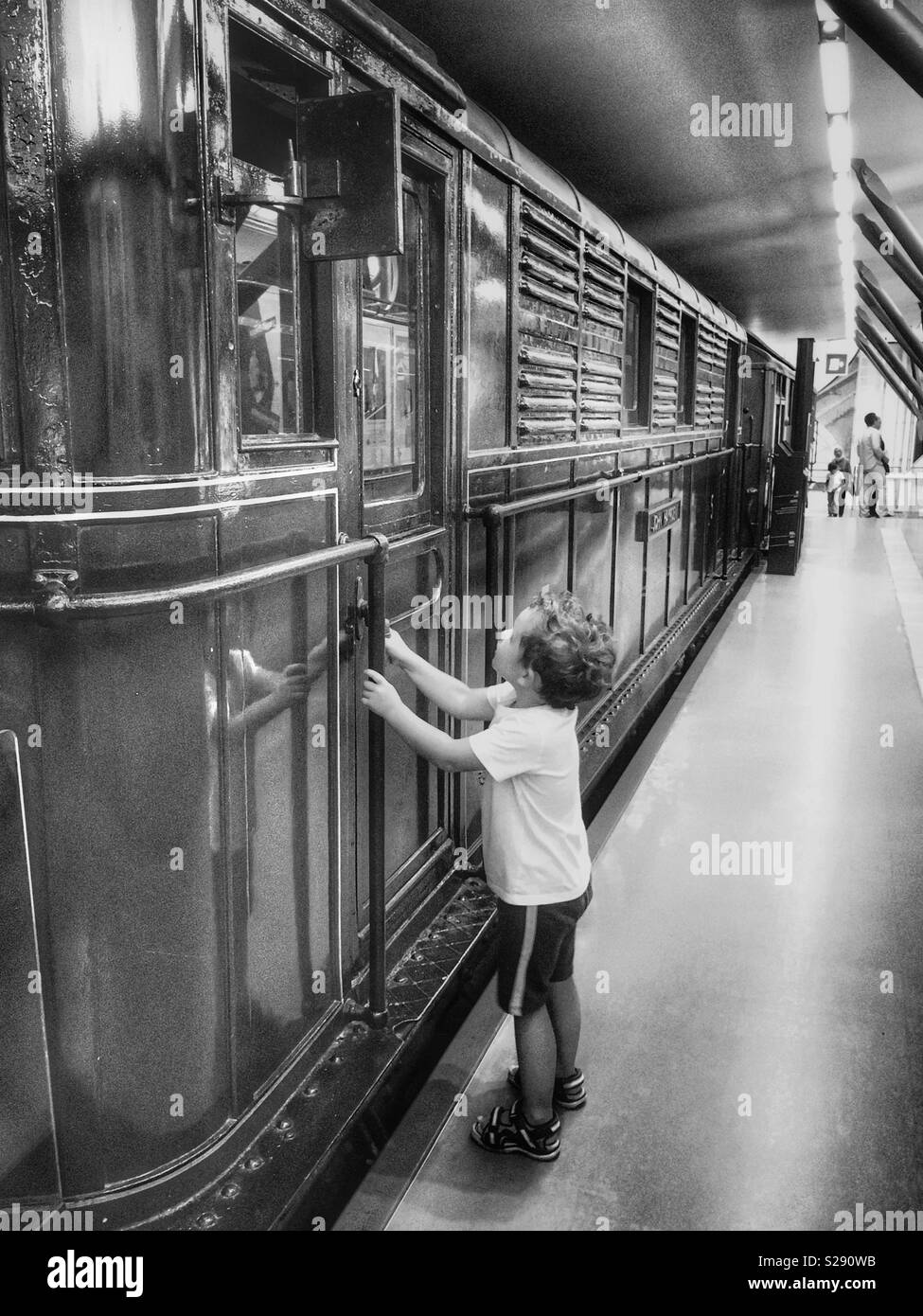 A boy looking at the train in London Transport Museum Stock Photo