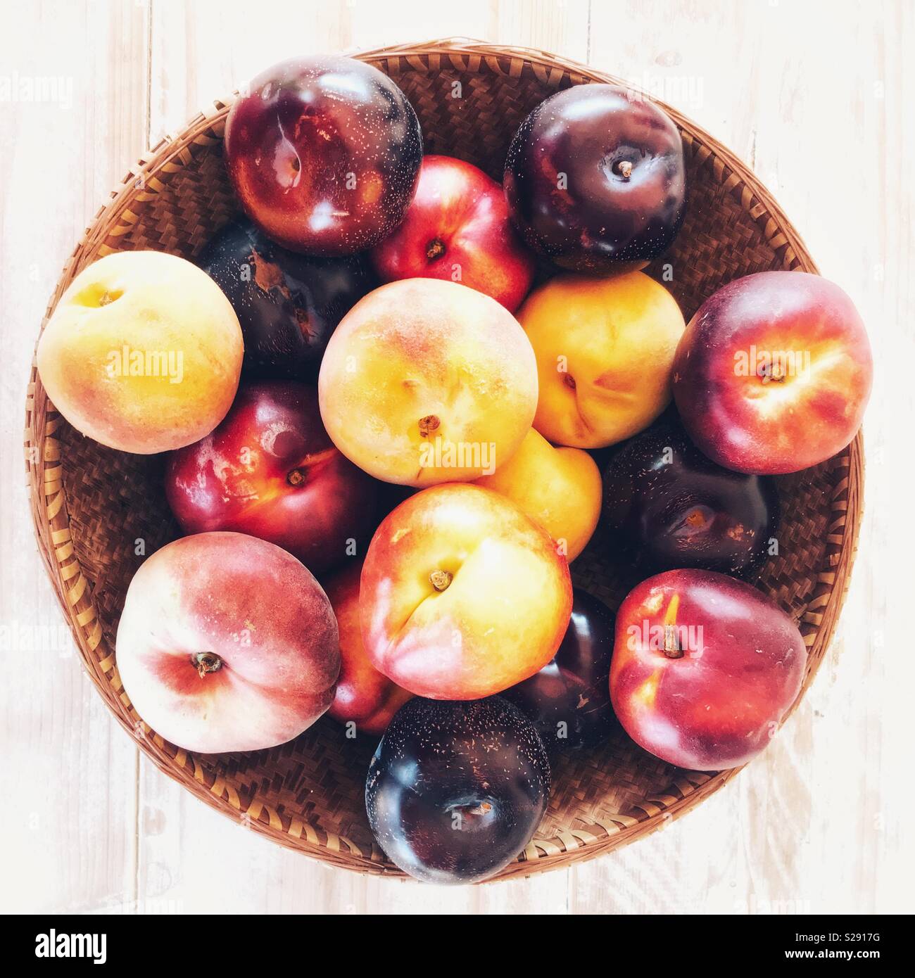 Basket of plums, peaches and nectarines Stock Photo