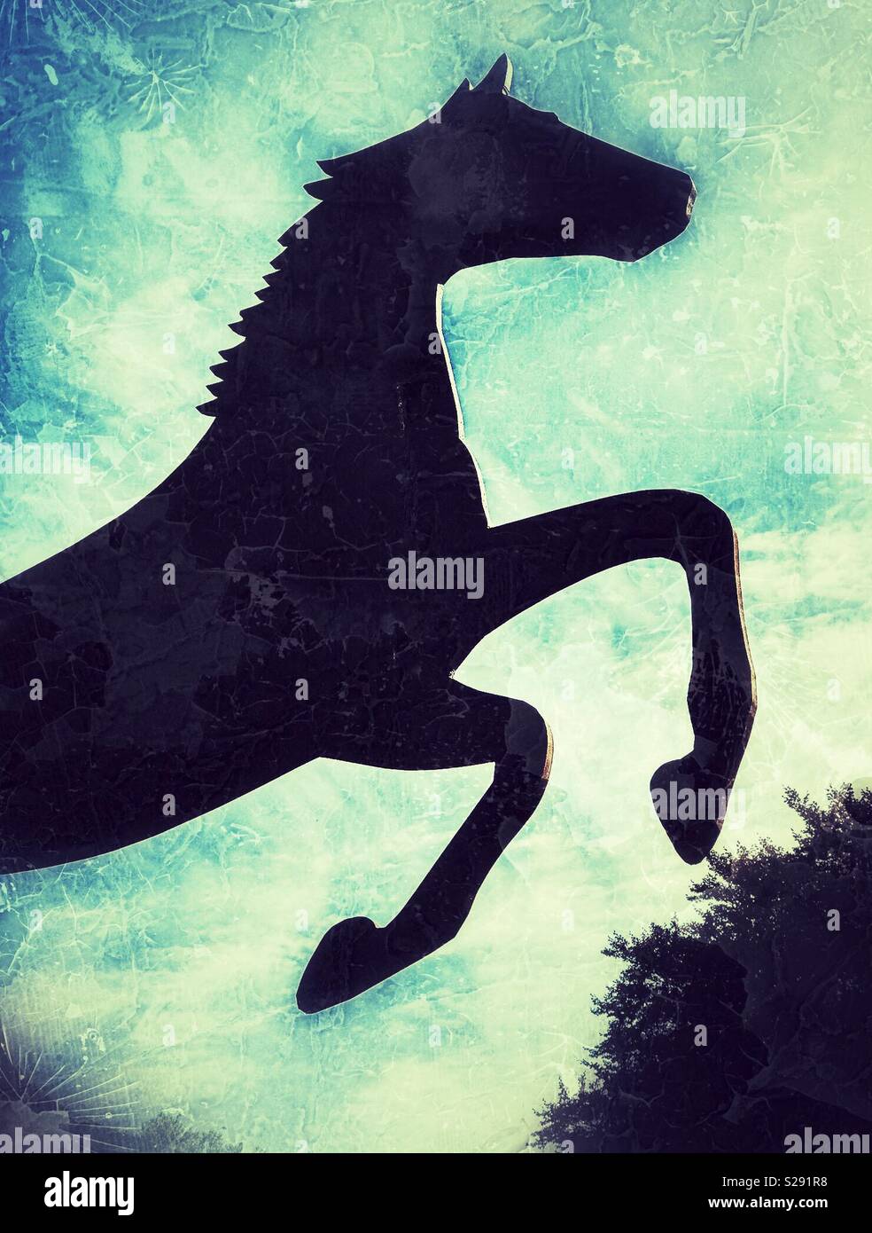 Silhouette of metal horse sculpture pawing the air - Smartphone Captured Stock Image